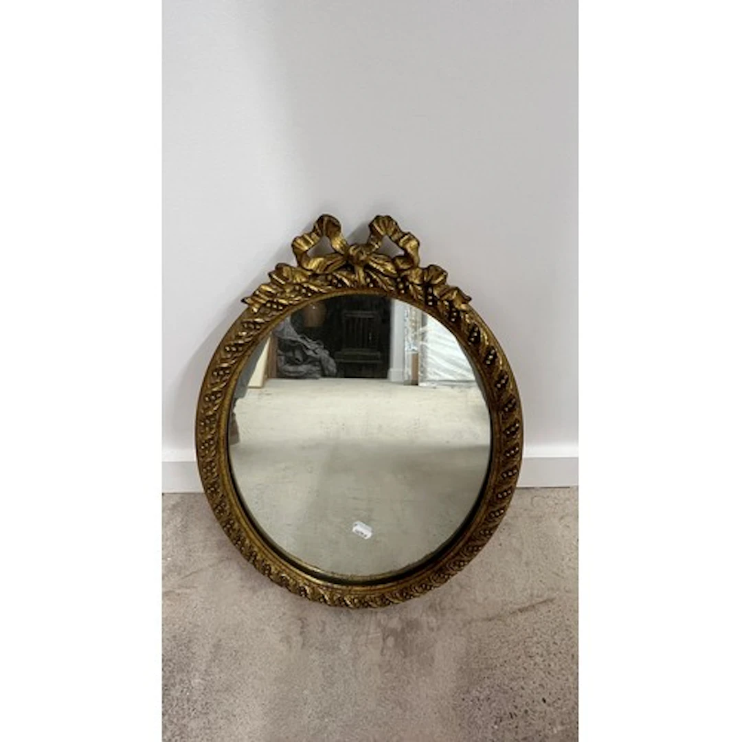 Gilt framed oval wall mirror with ribbon bow surmount, 50cm ...