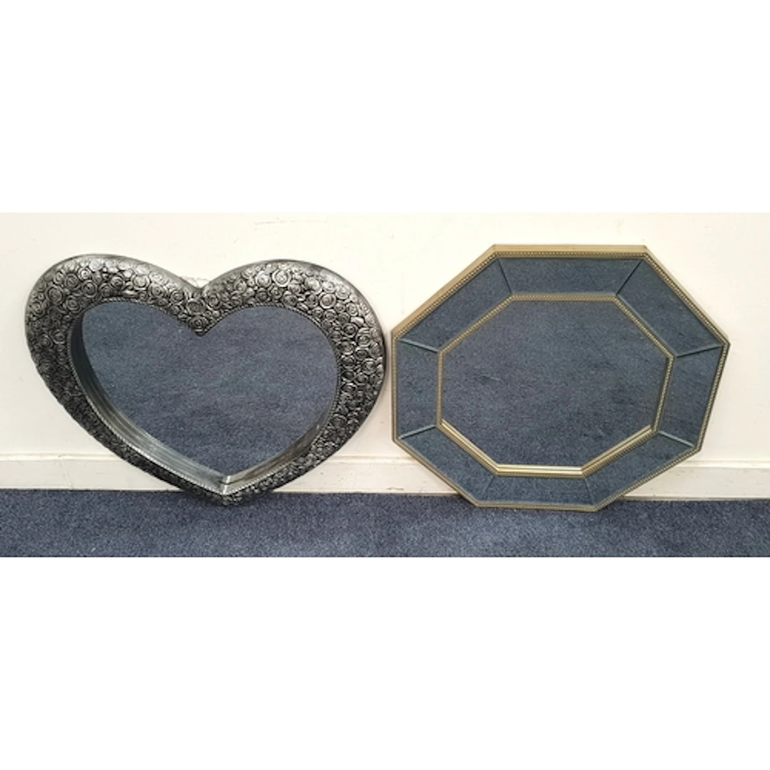 TWO CONTEMPORARY WALL MIRRORS comprising one of heart shape,...