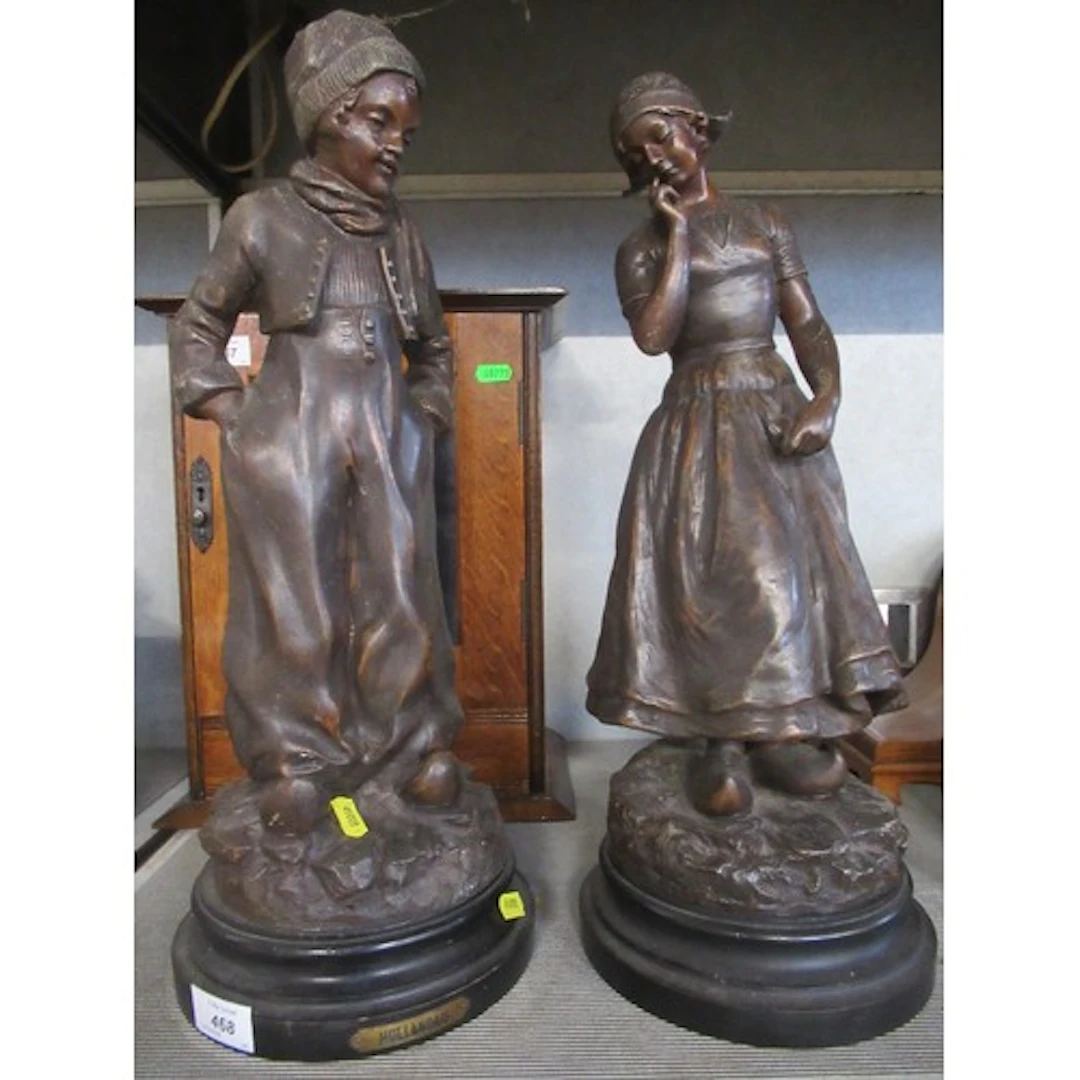 A pair of Spelter figures one signed G Bailey