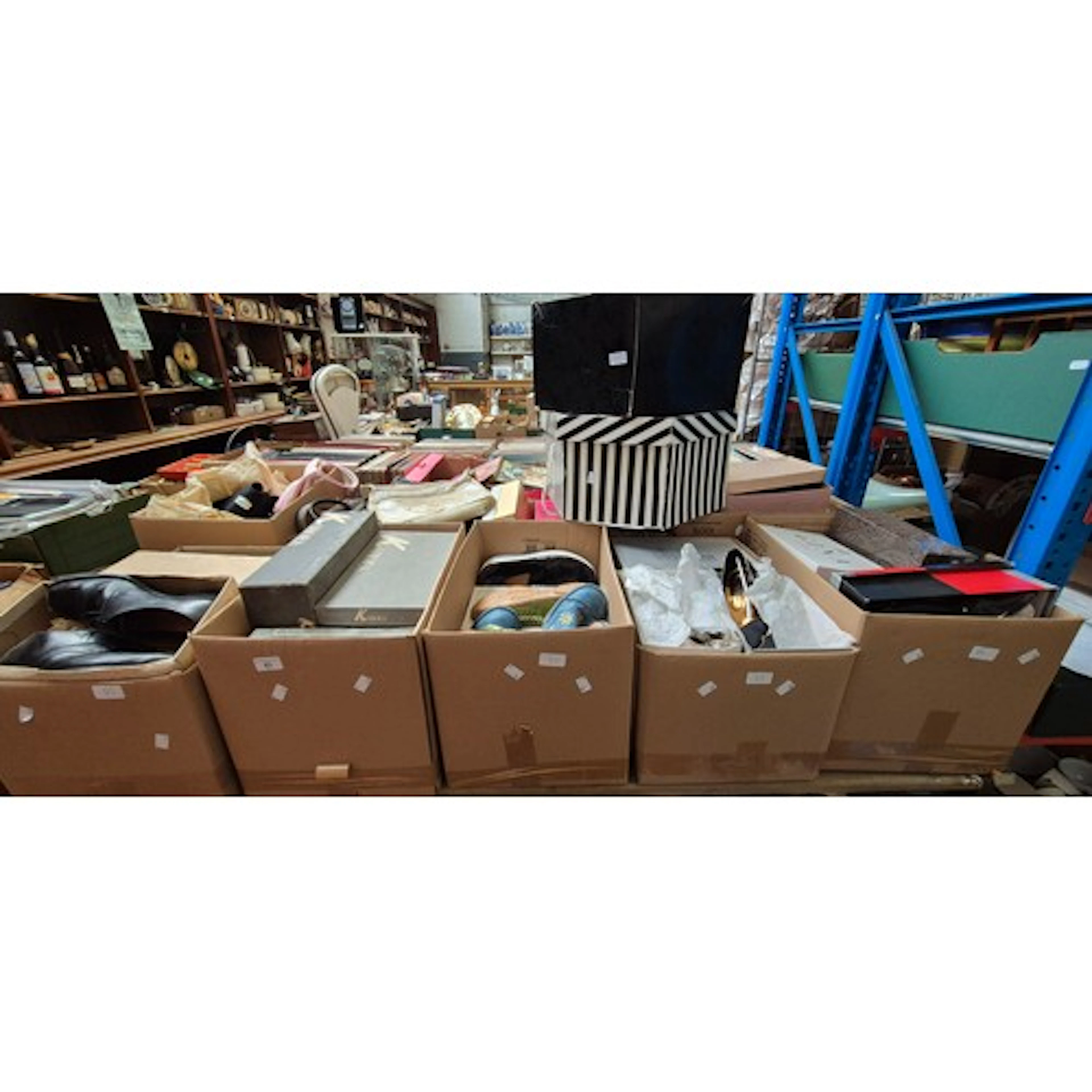A table top of items comprising 9 boxes of shoes, handbags e...