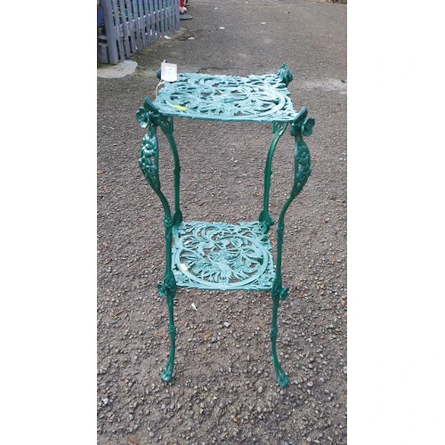 Green-painted cast-metal two-tier garden stand, its pierced ...