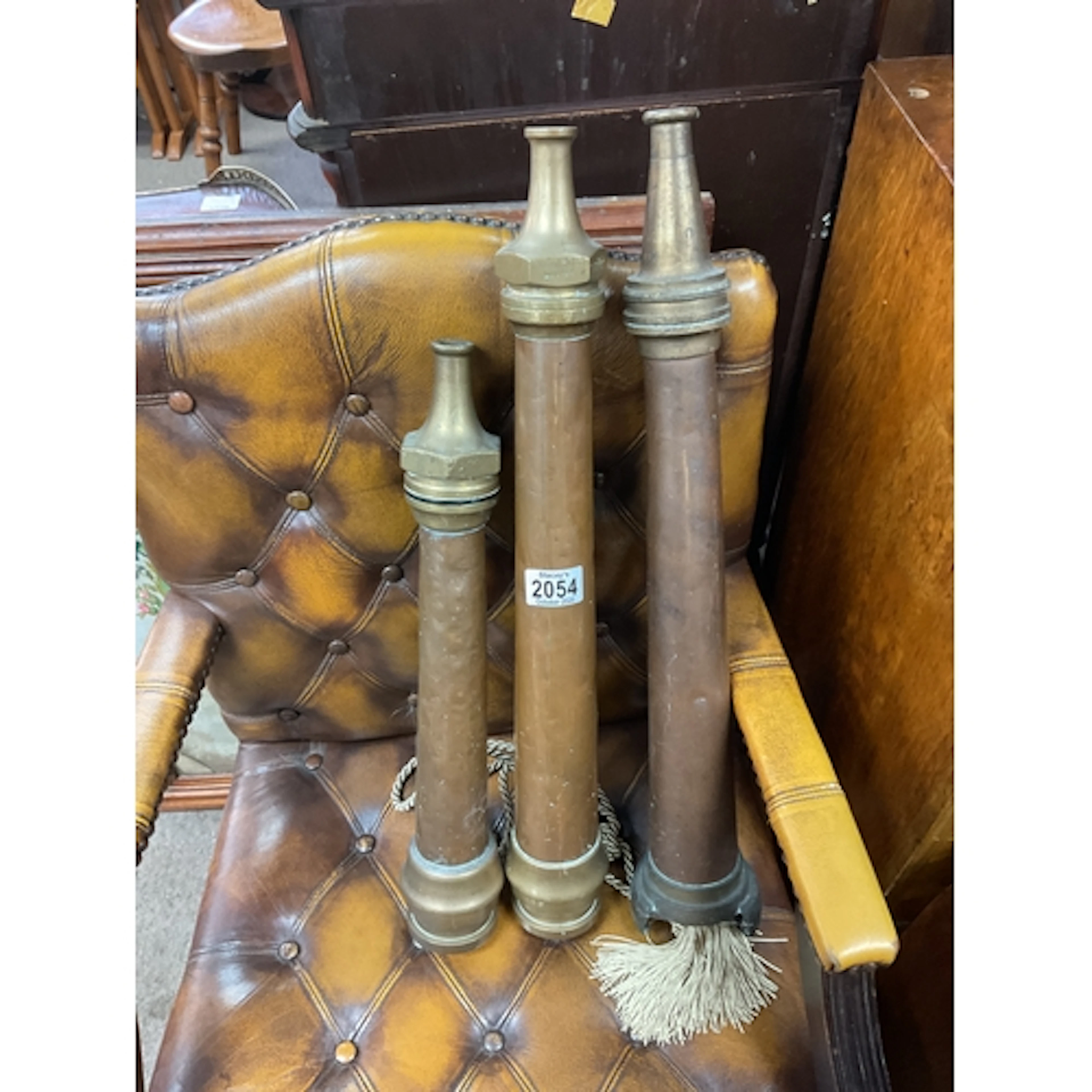 Three vintage copper and brass fireman’s hose branches...
