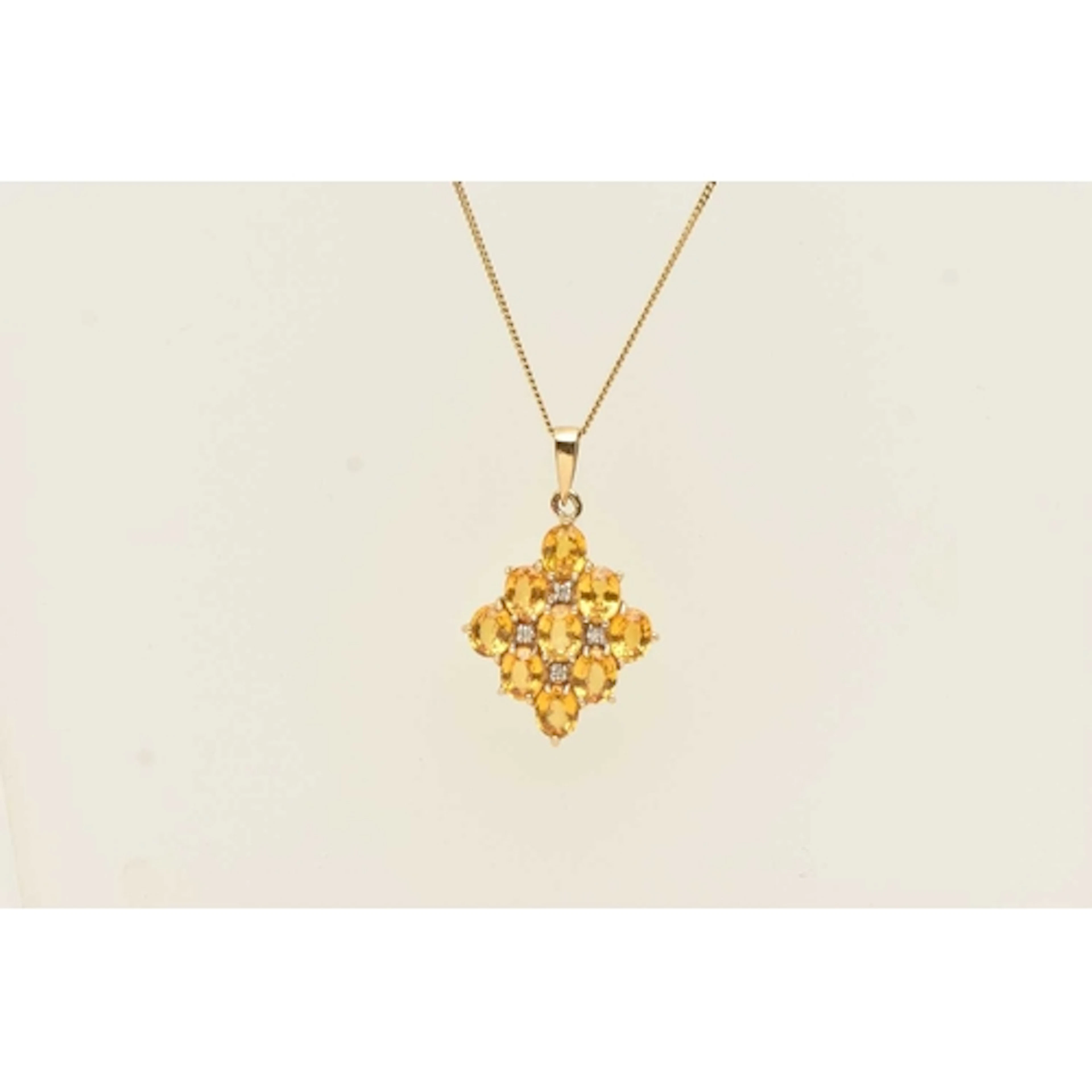 A 9CT YELLOW GOLD GEM SET PENDANT NECKLACE, oval cut yellow ...