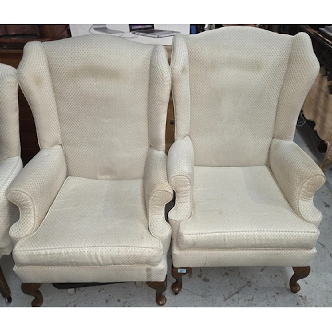 A pair of wing back armchairs on cabriole legs in Art Deco f...
