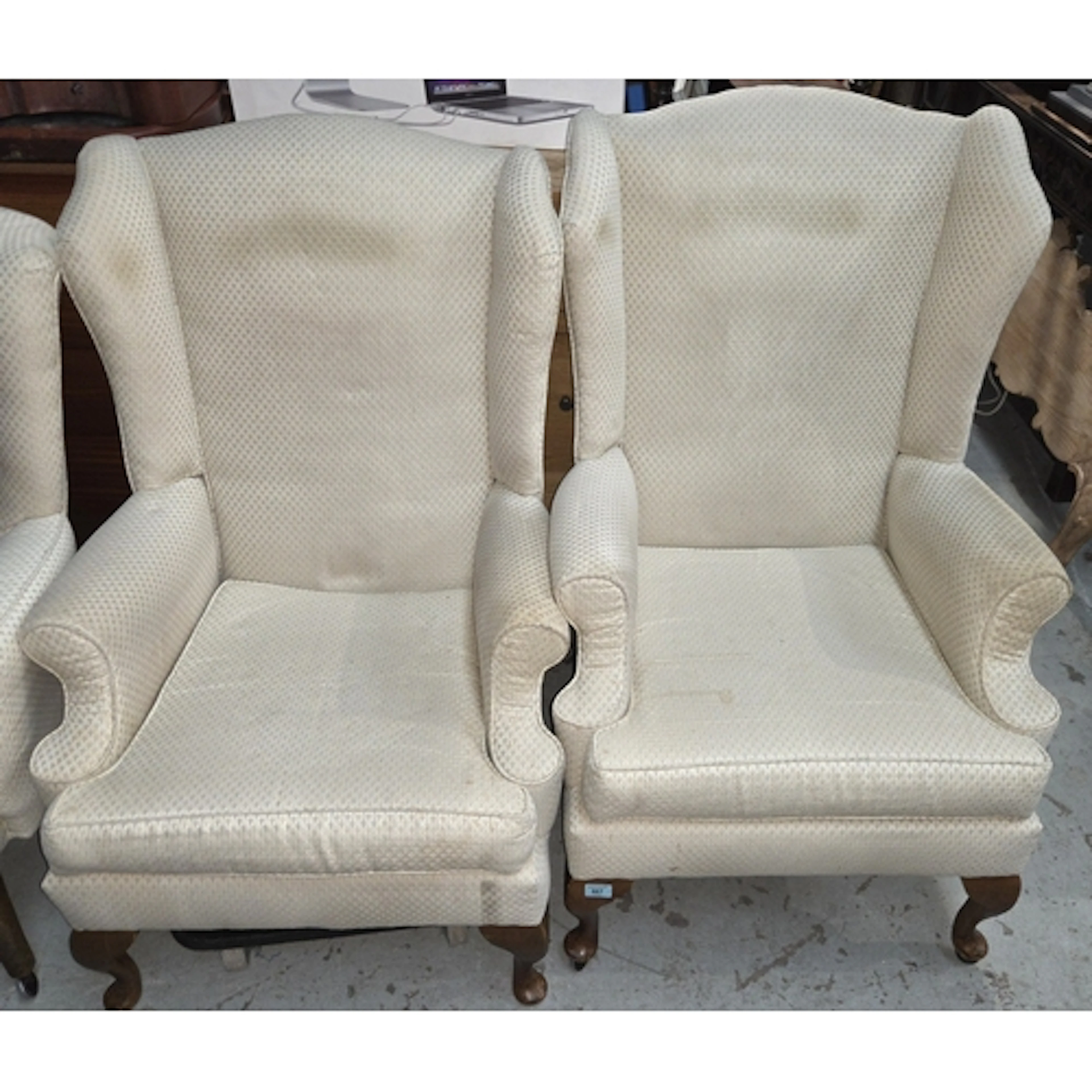 A pair of wing back armchairs on cabriole legs in Art Deco f...