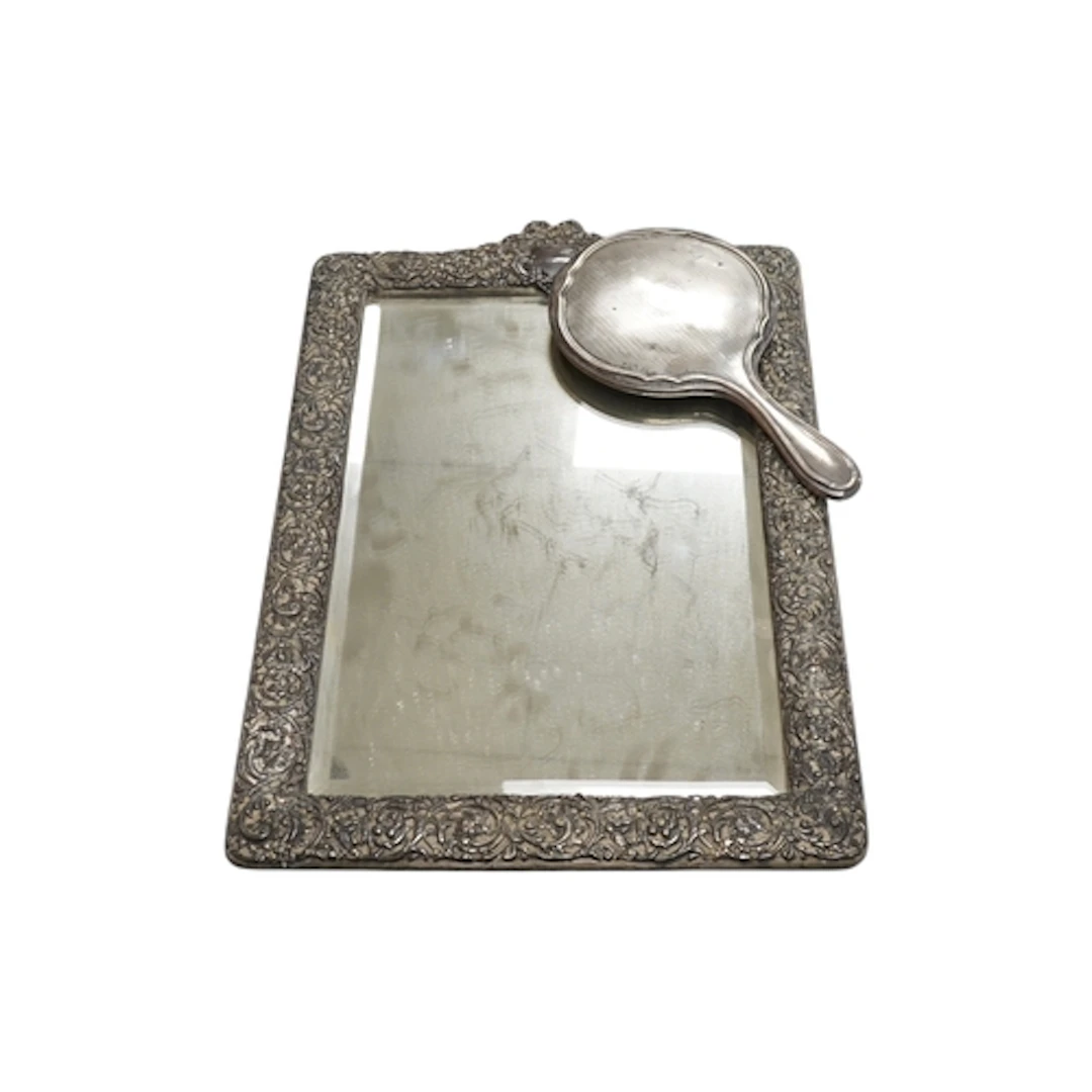 An Edwardian repousse silver mounted rectangular easel mirro...