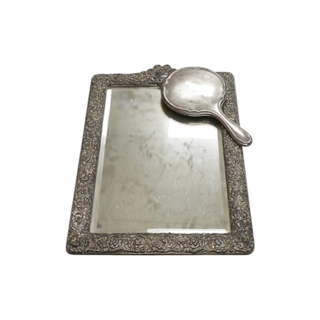 An Edwardian repousse silver mounted rectangular easel mirro...