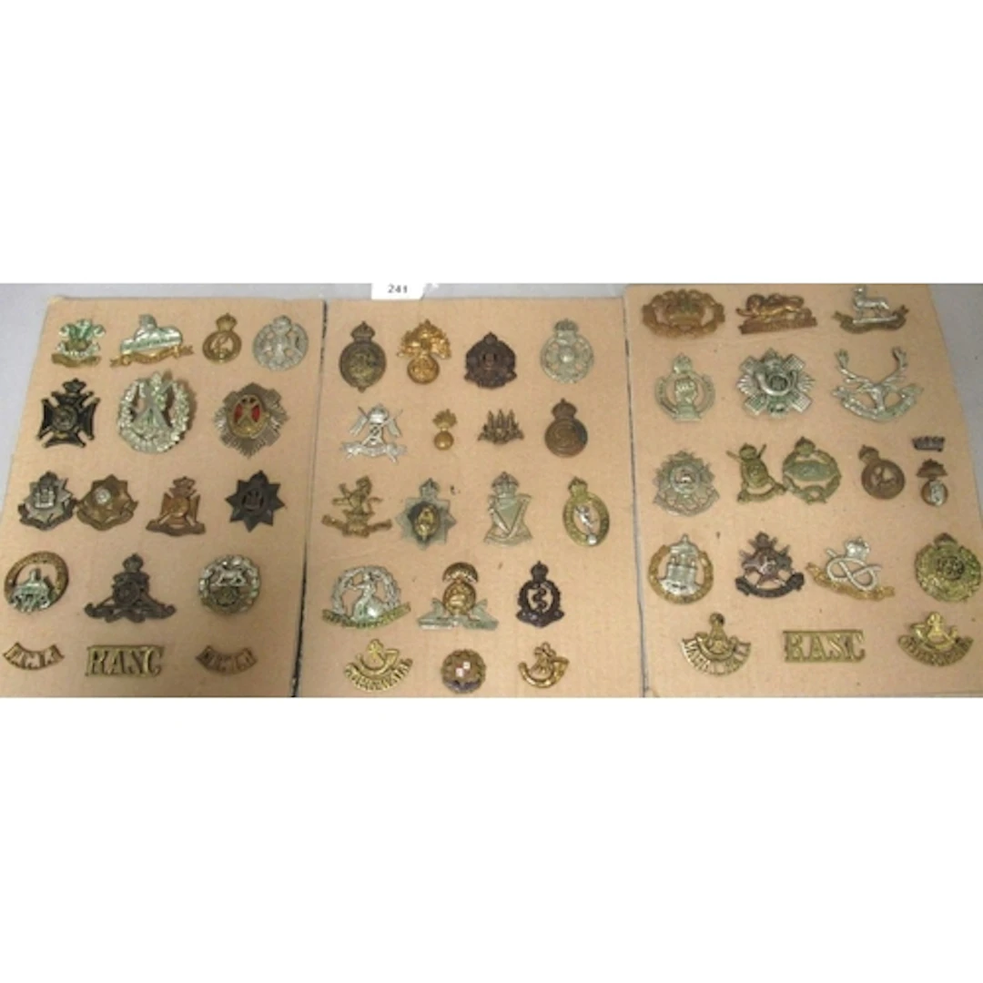 Collection of approximately fifty four military cap badges