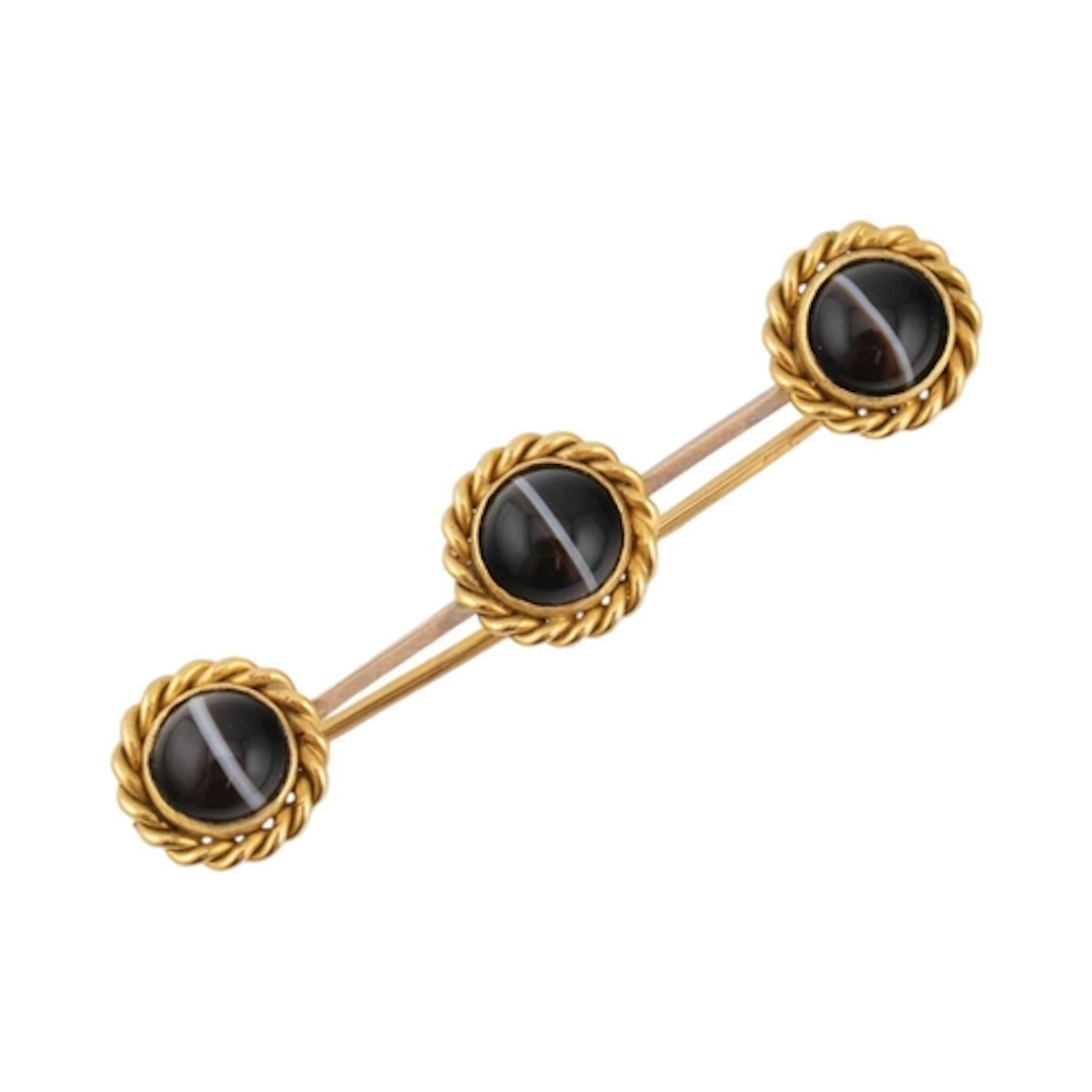 An early 20th century gold and banded agate three-stone broo...