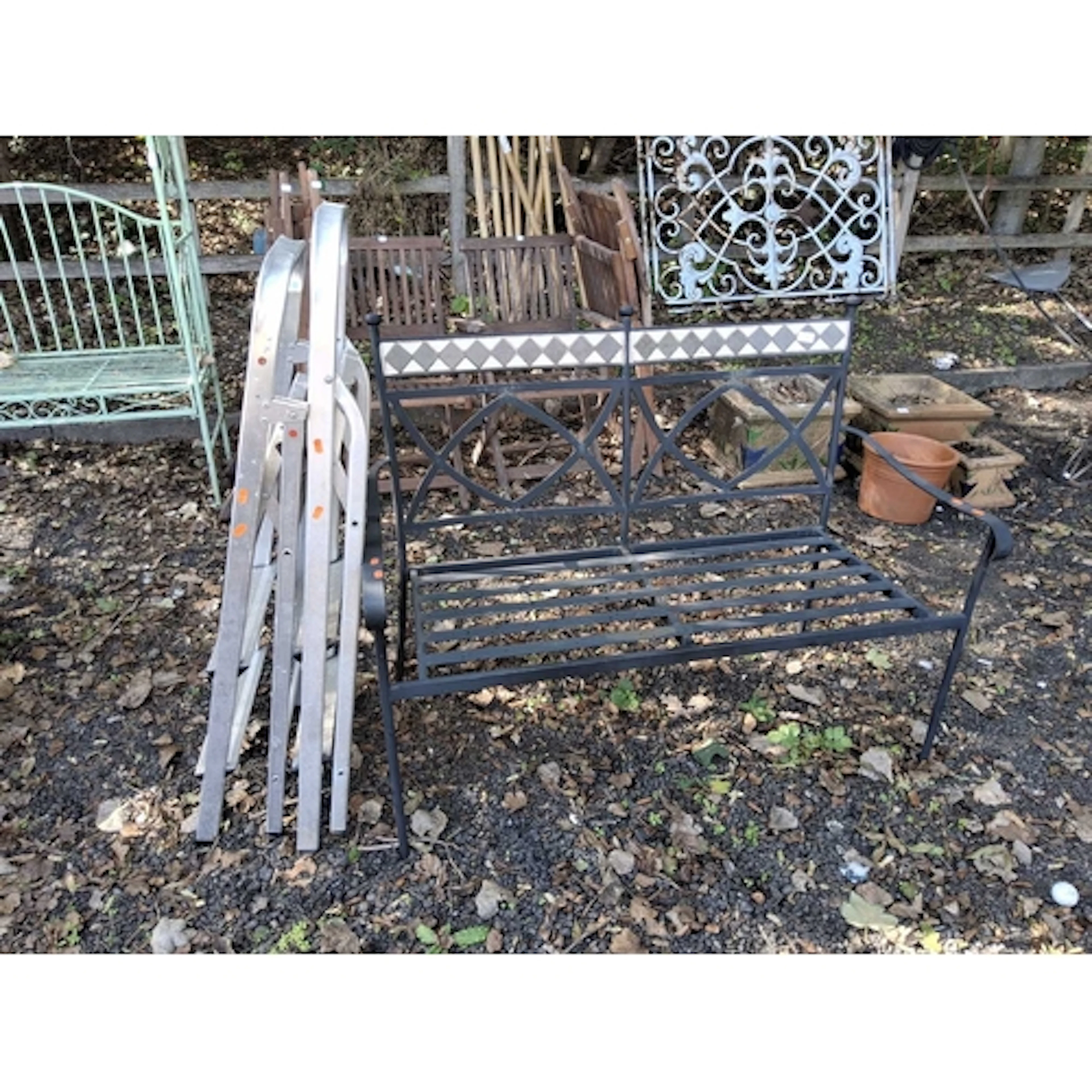 A MODERN STEEL GARDEN BENCH WITH TILED FRIEZE TO BACK and tw...