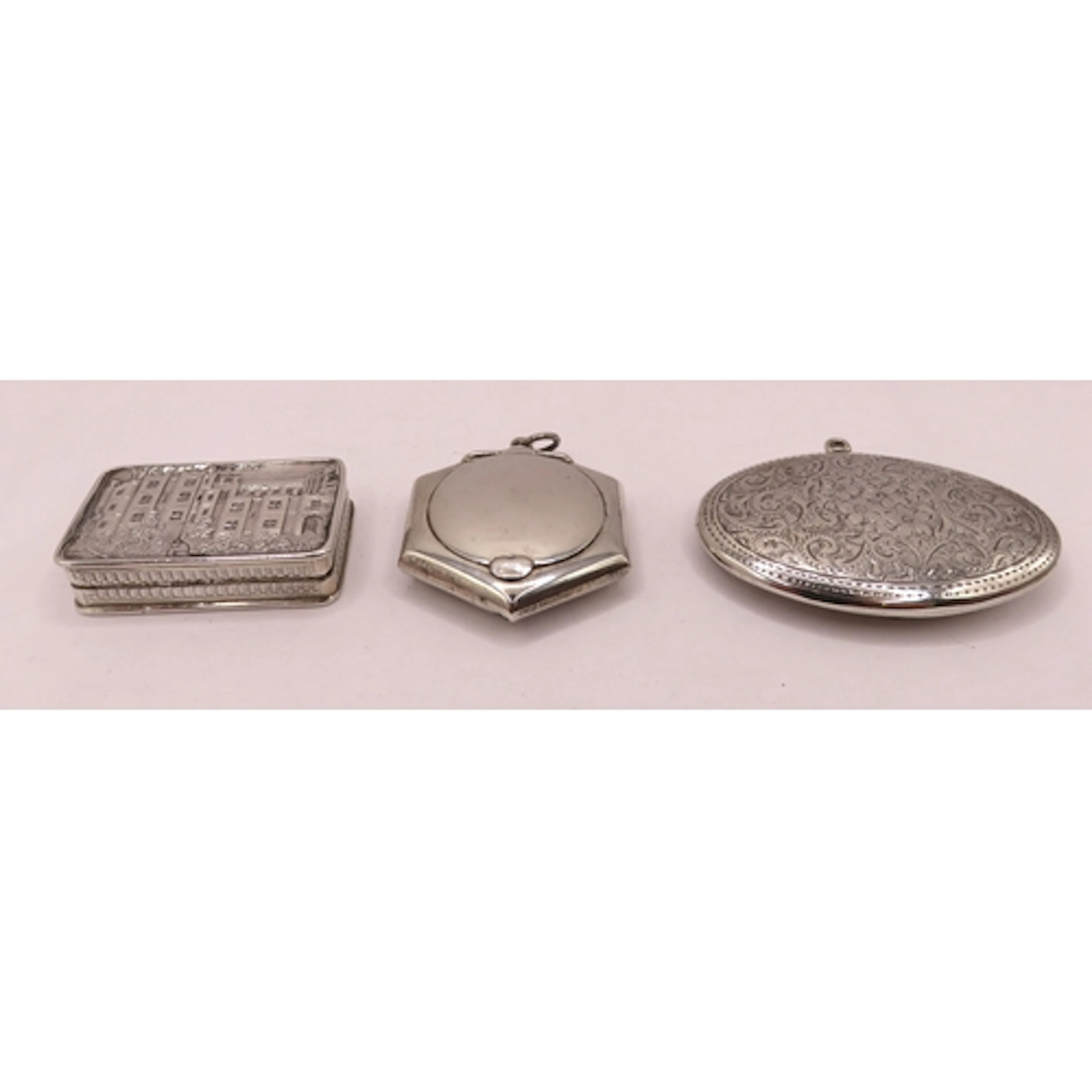 Two oval silver pendant boxes, together with a rectangular V...