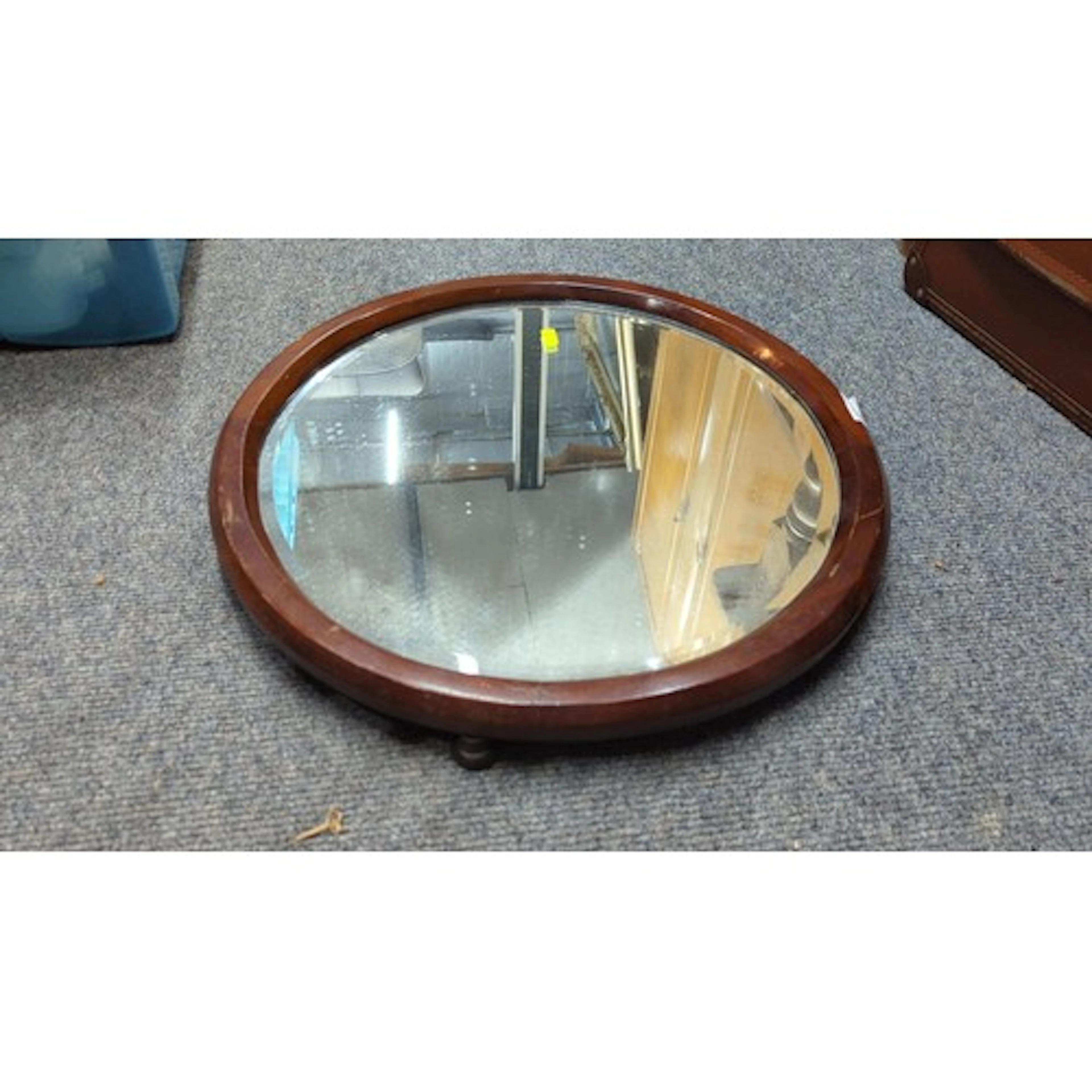 A circular mahogany-framed mirror, with bevelled glass plate...