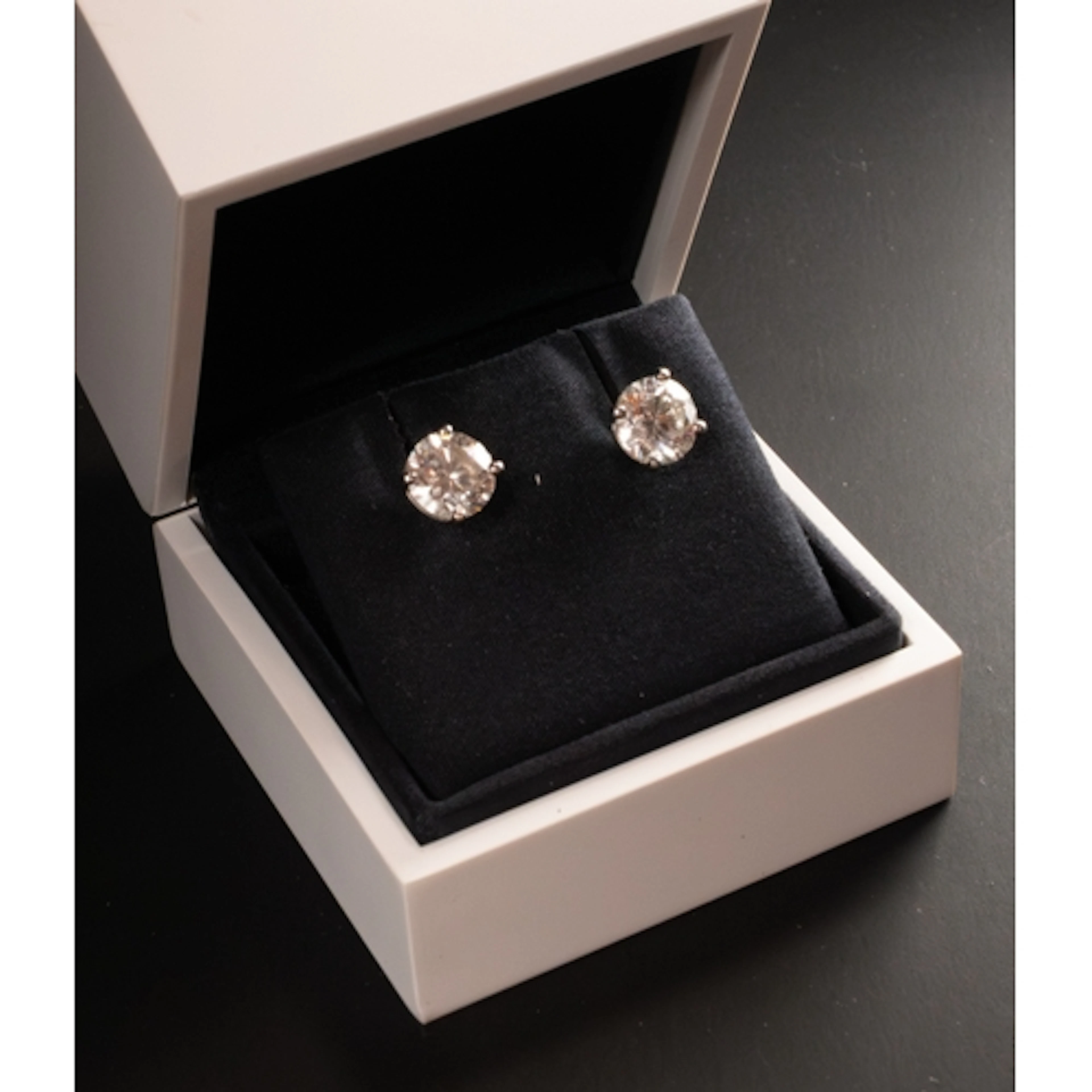Jewellery: De Beers- a pair of solitaire round brilliant cut...