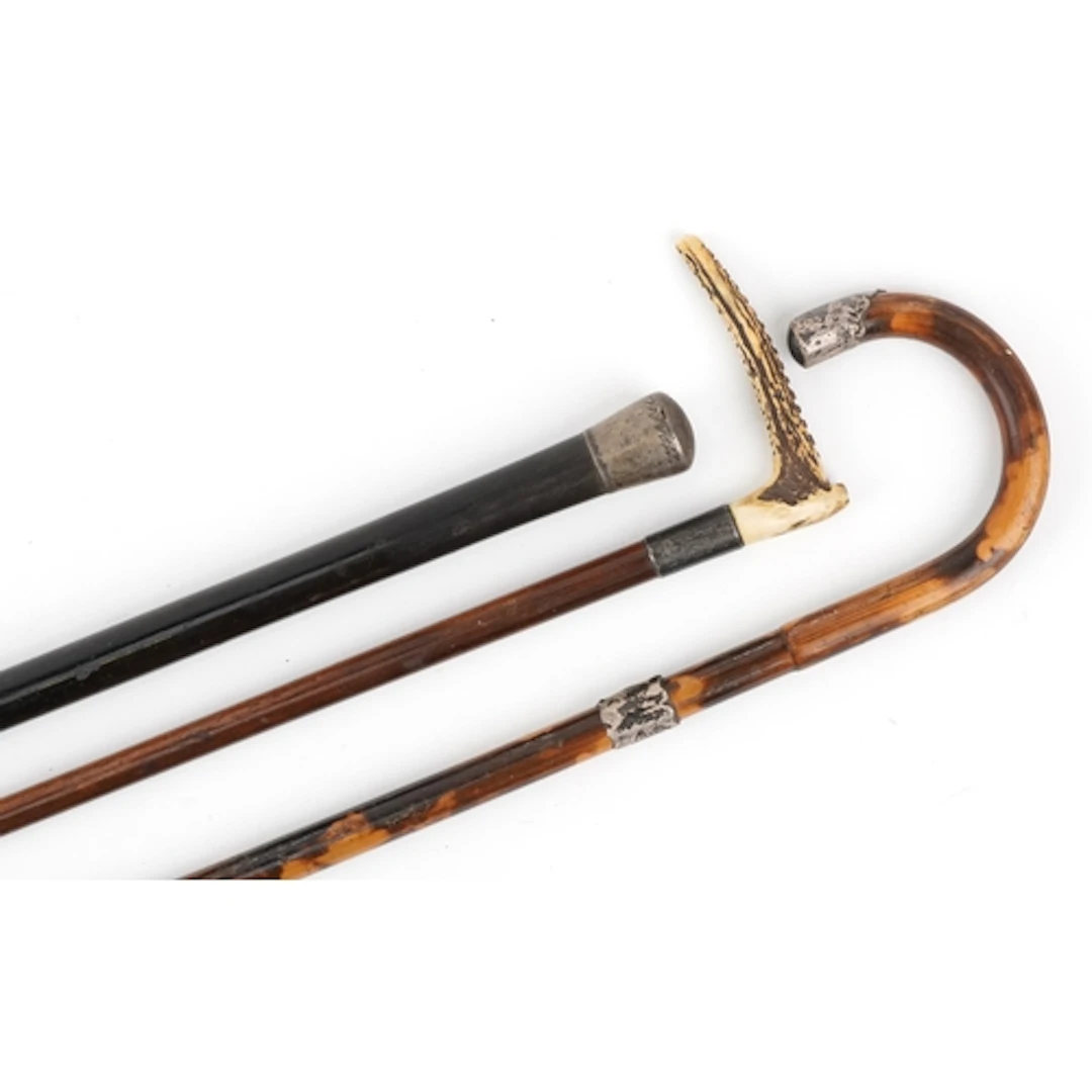 Three antique walking sticks with silver mounts, including a...