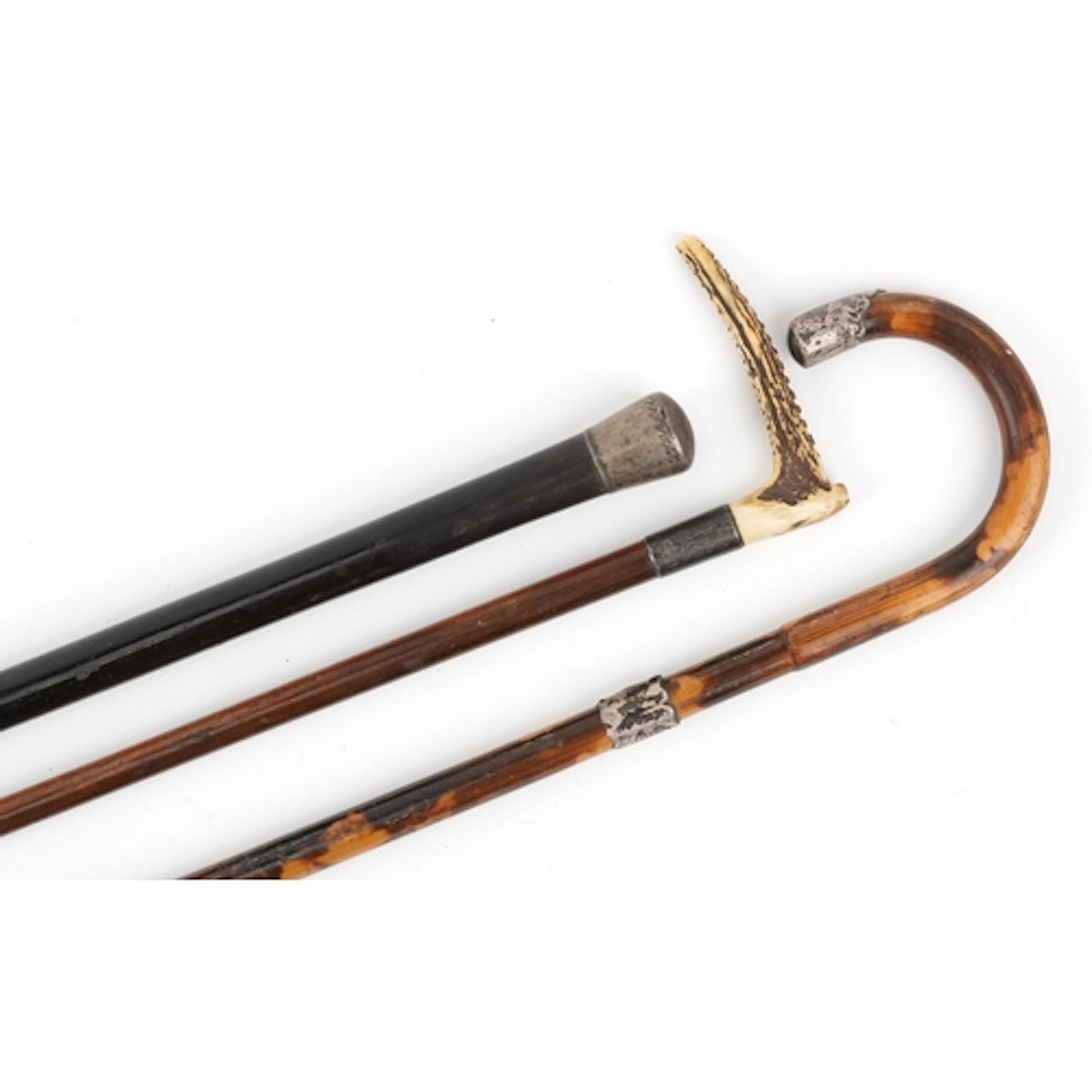 Three antique walking sticks with silver mounts, including a...