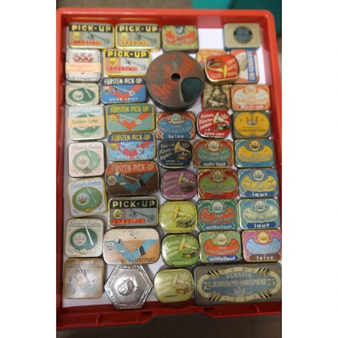 A tray of vintage gramophone needle tins