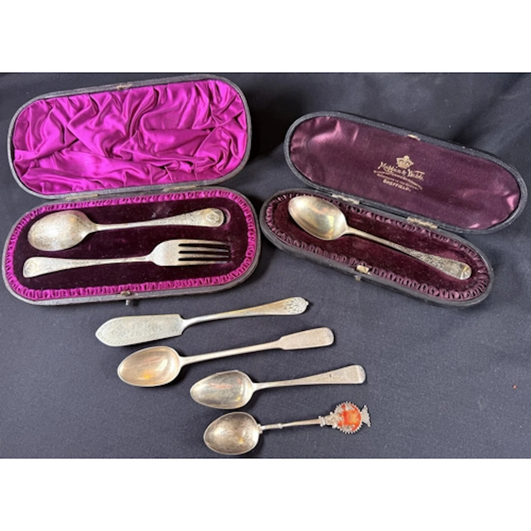 A hallmarked silver christening spoon and fork with chased d...