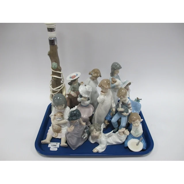 Eleven Lladro porcelain figures, including reclining angel f...