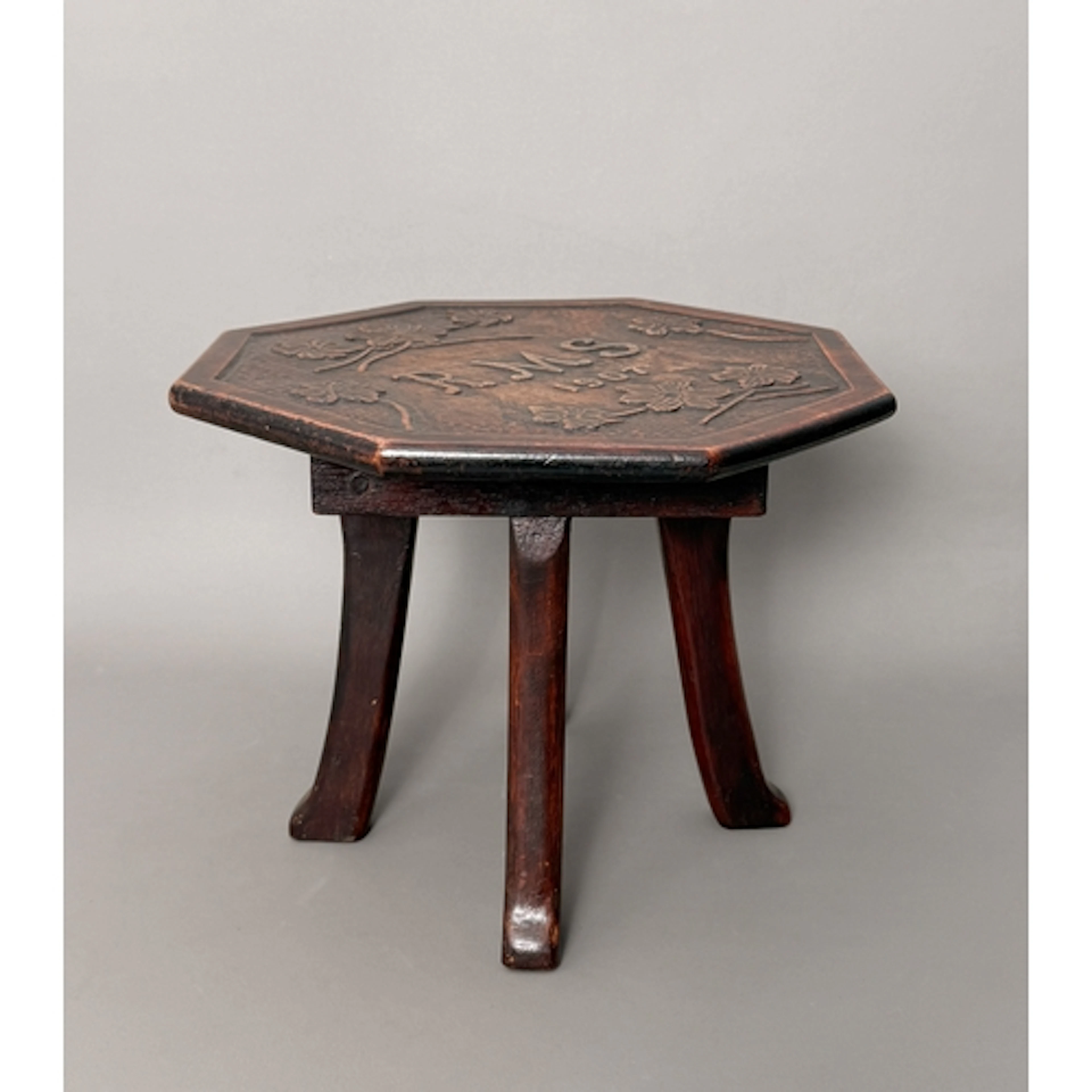 A small Arts and Crafts four legged mahogany stool - the oct...
