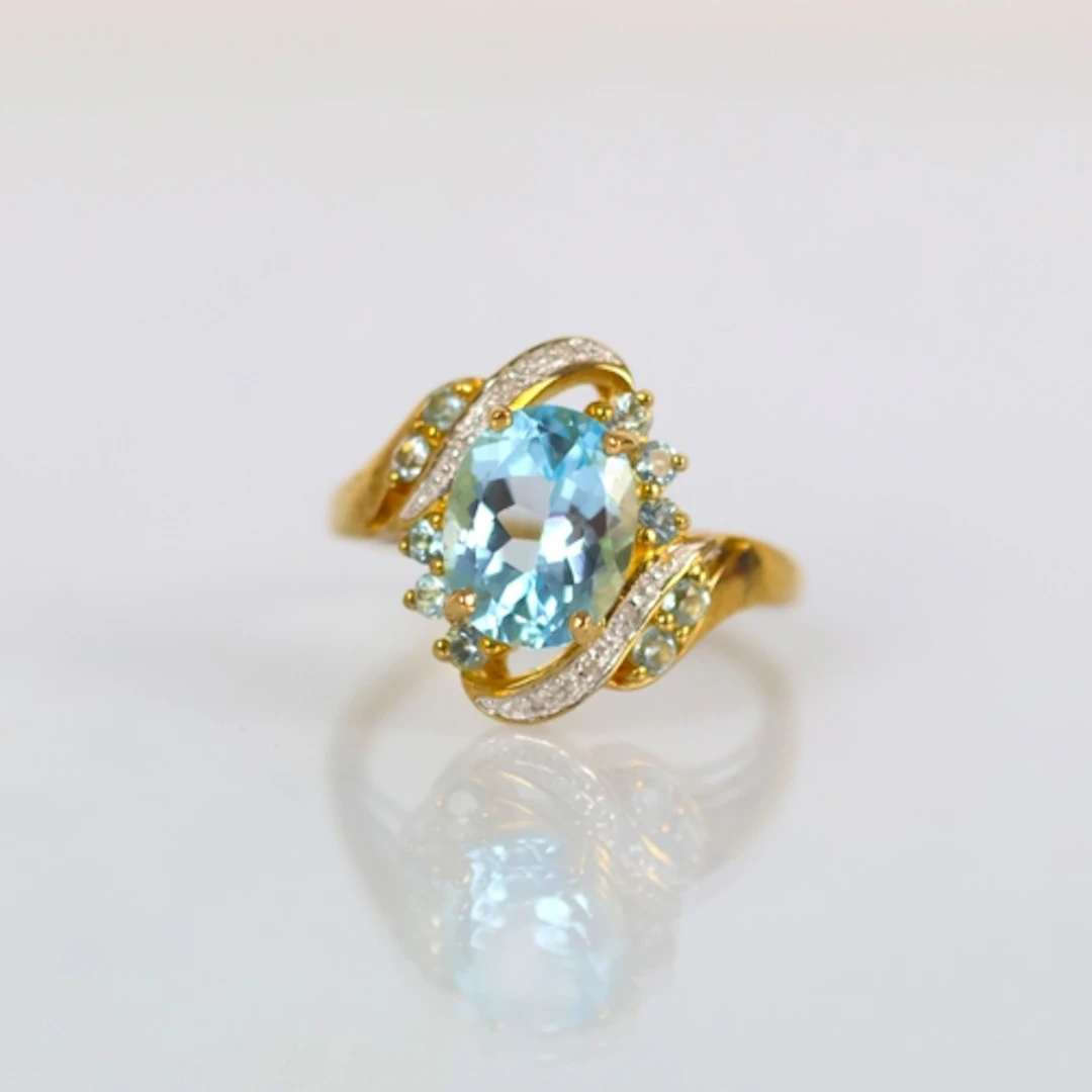 A contemporary 9ct gold dress ring, the blue stone (possibly...