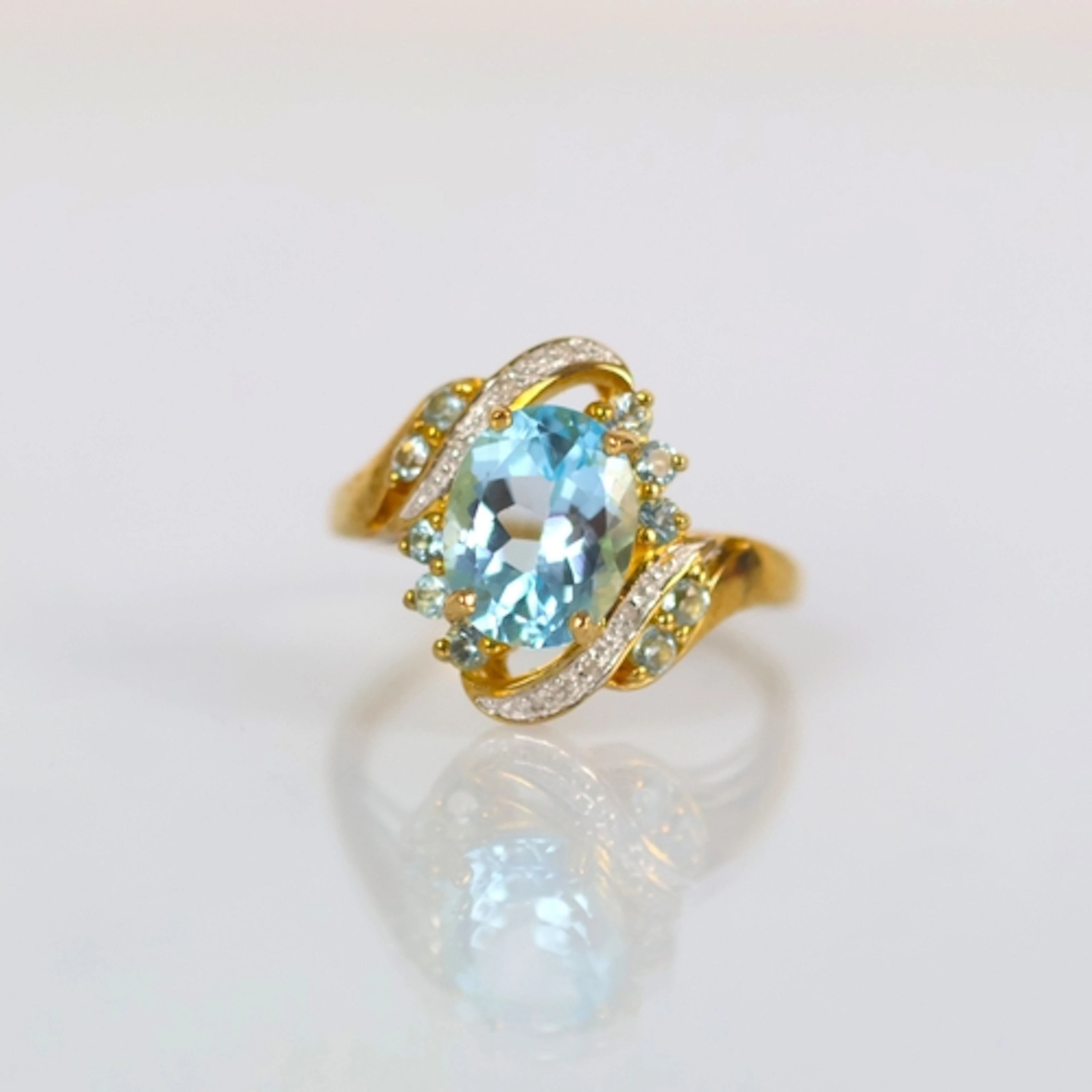 A contemporary 9ct gold dress ring, the blue stone (possibly...