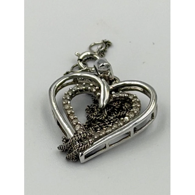 A 9ct white gold heart pendant on fine necklace, approximate...