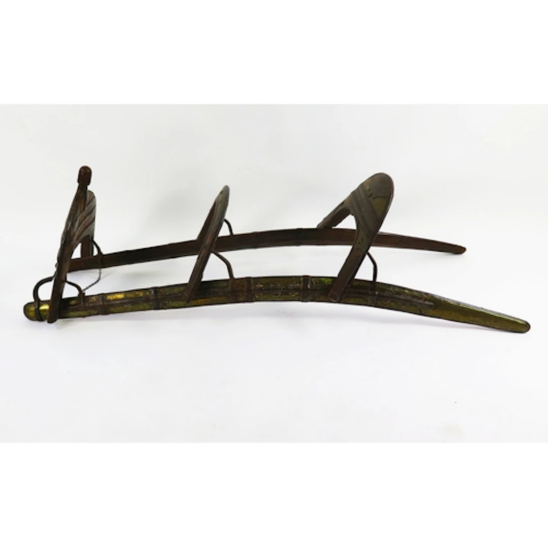 A North African hardwood double camel saddle, with decorativ...