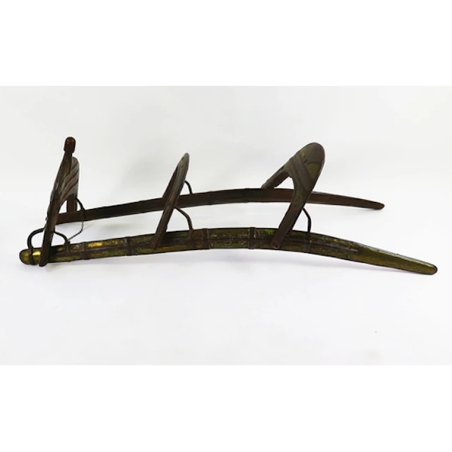 A North African hardwood double camel saddle, with decorativ...