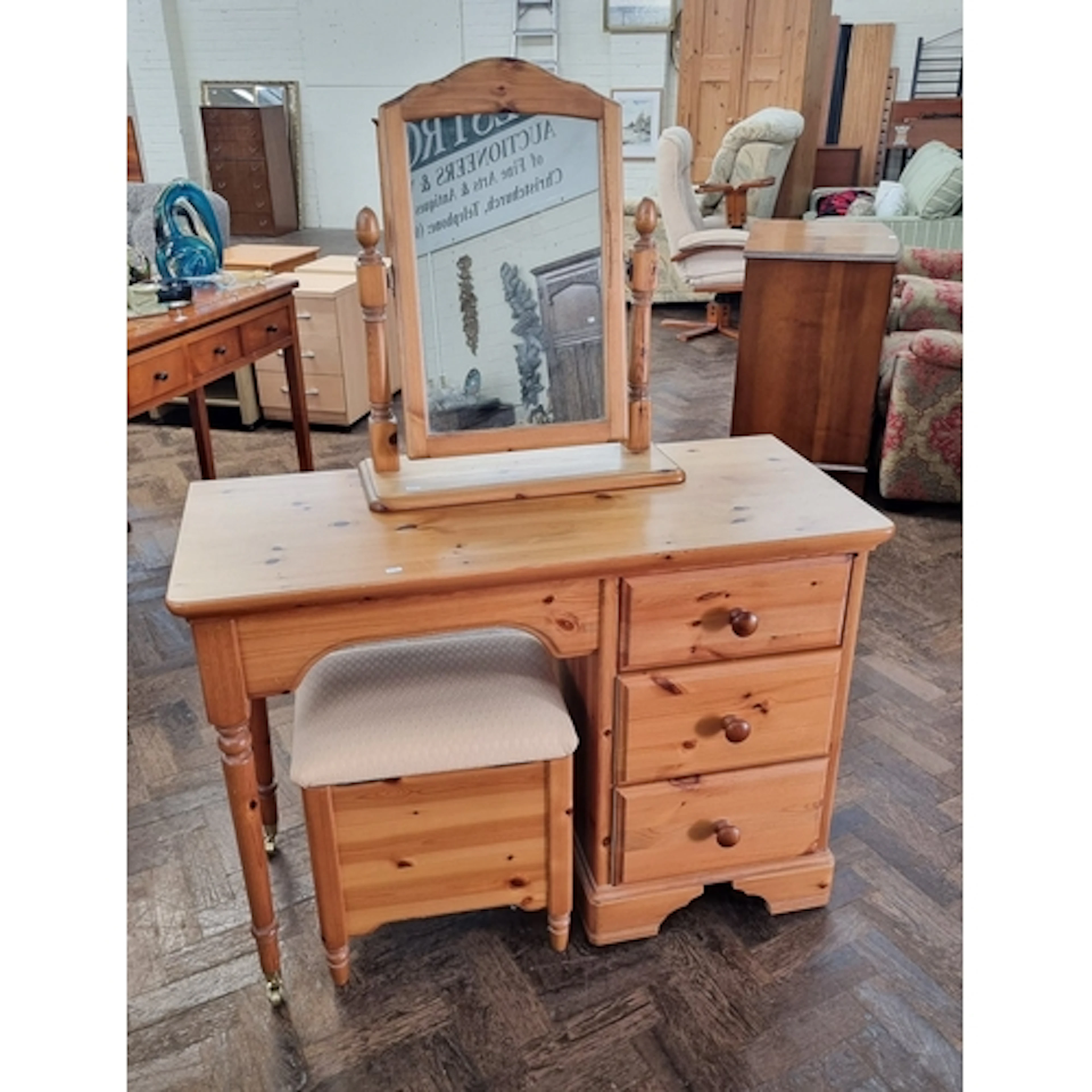 A modern pine single pedestal three drawer dressing table wi...