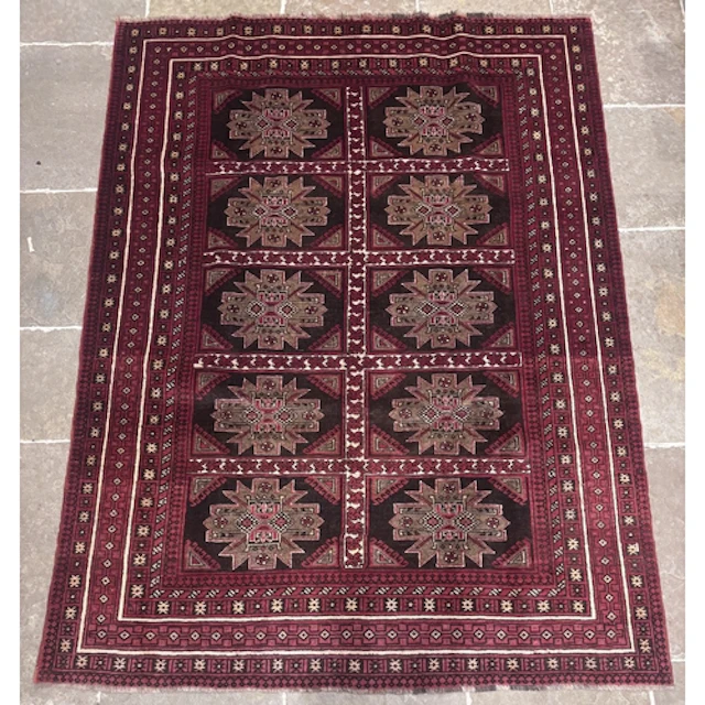 A large handwoven Persian Baluch rug, in ivory, red and blac...
