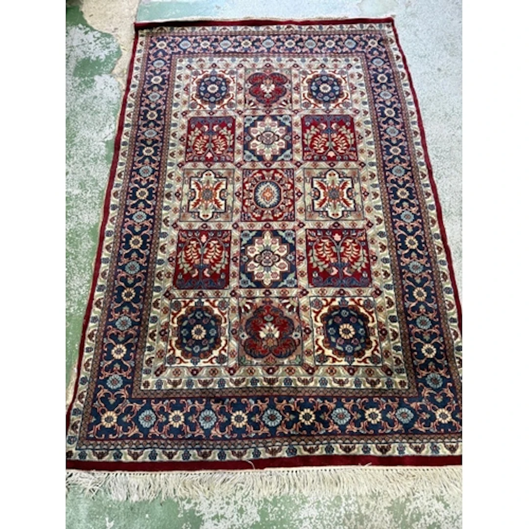 A wool rug. Blue grounds with floral border. 193x123cm...