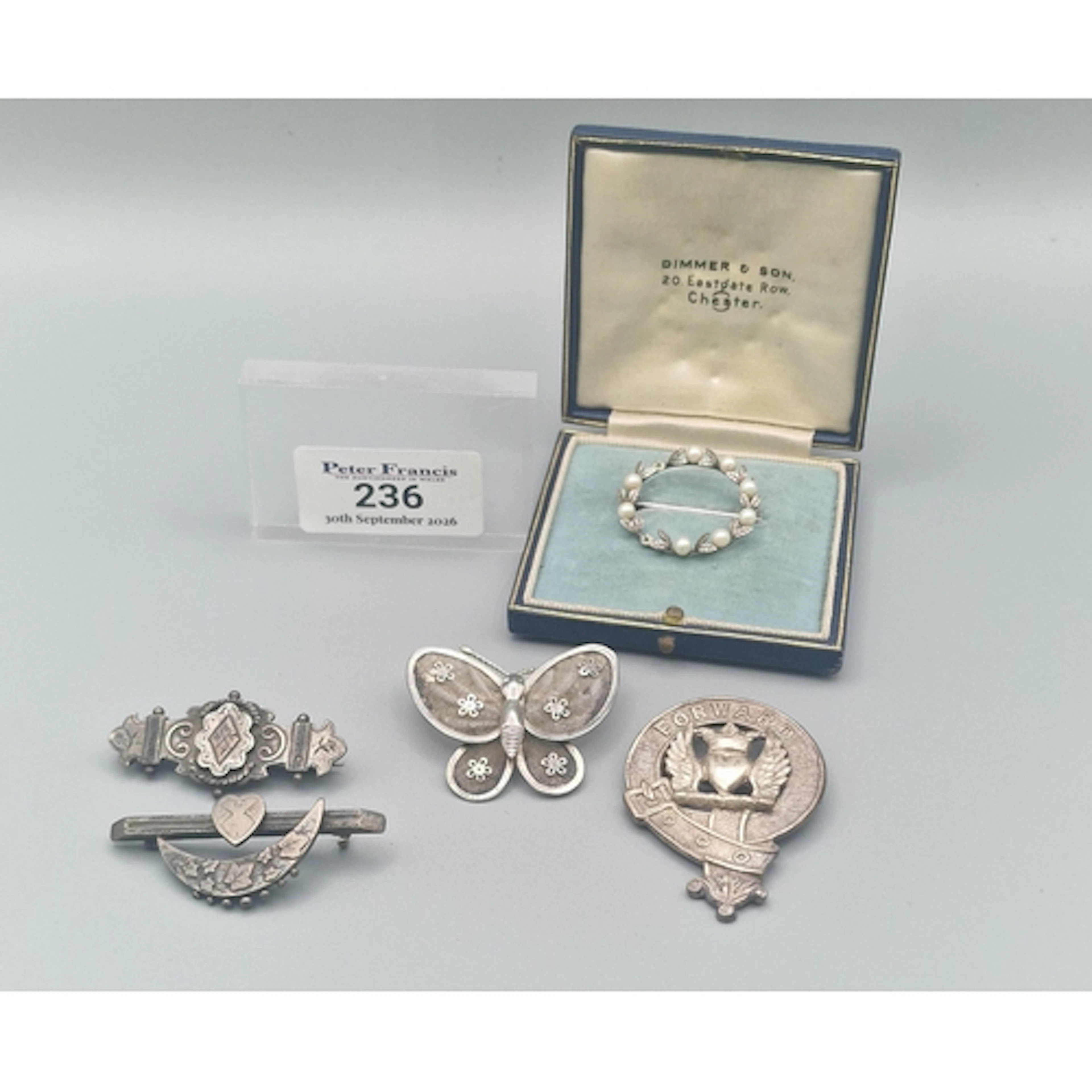 Two Victorian silver brooches, together with a white metal f...