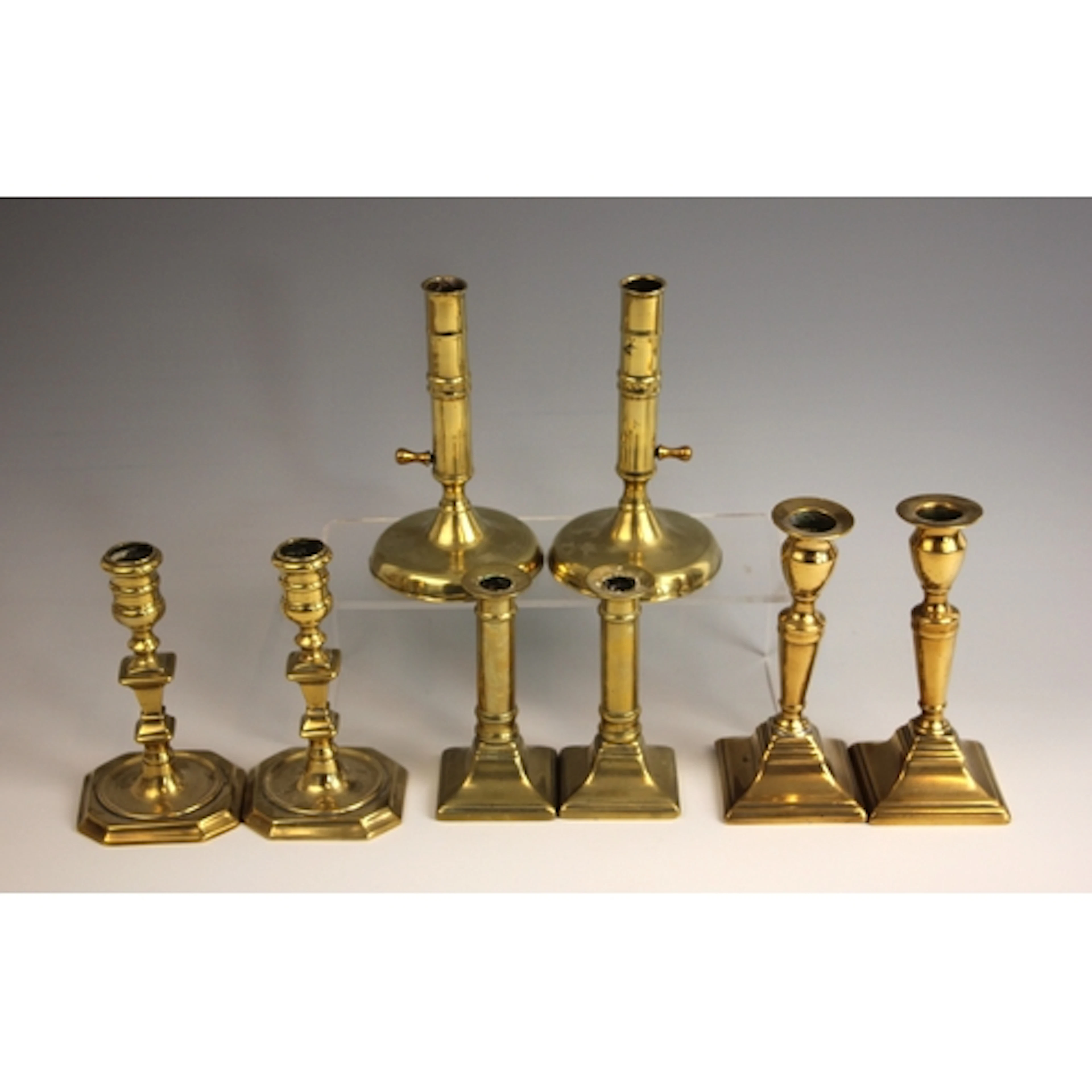 A pair of brass ejector candlesticks, 19th century, the knop...