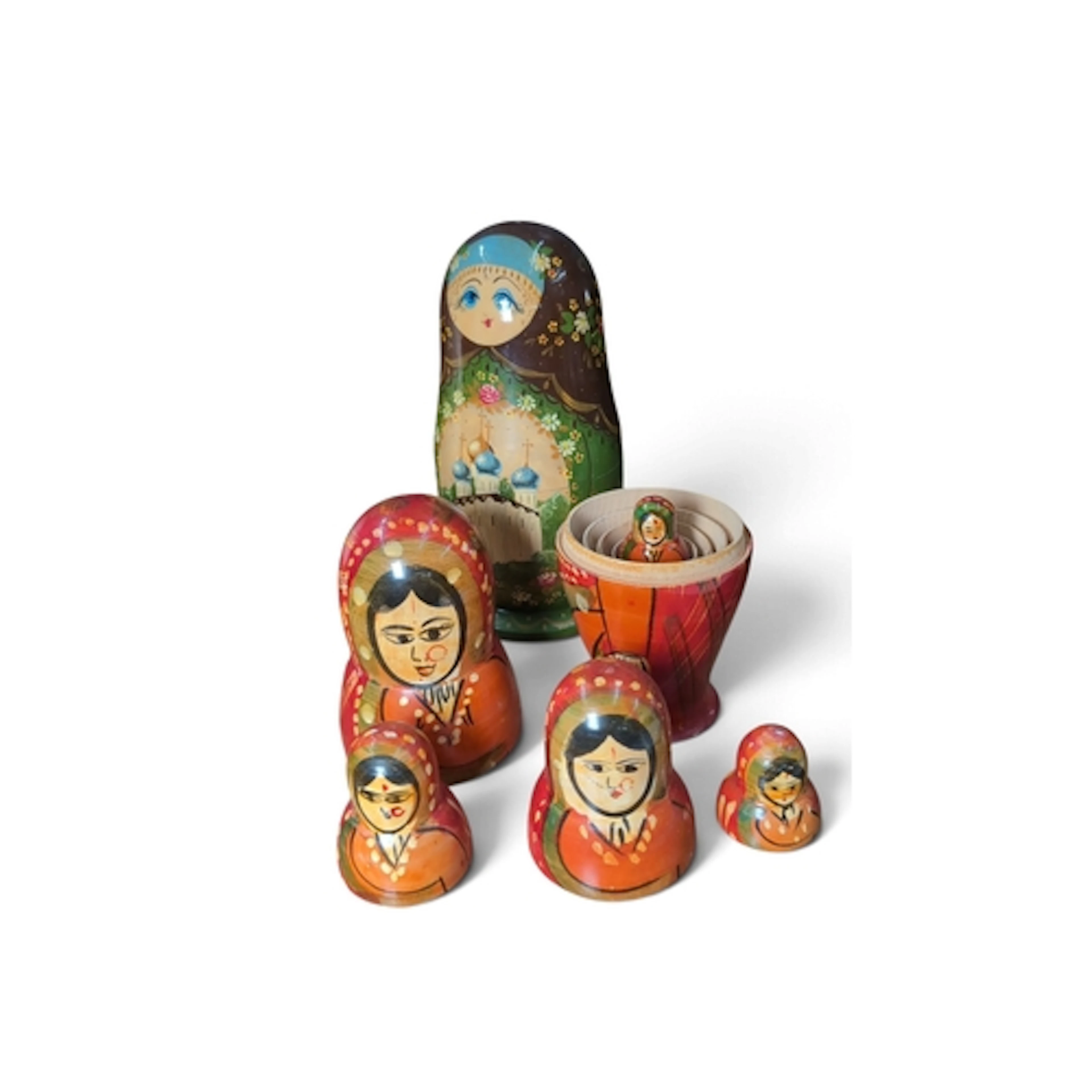 A group of hand-painted wooden nesting dolls, including a ma...