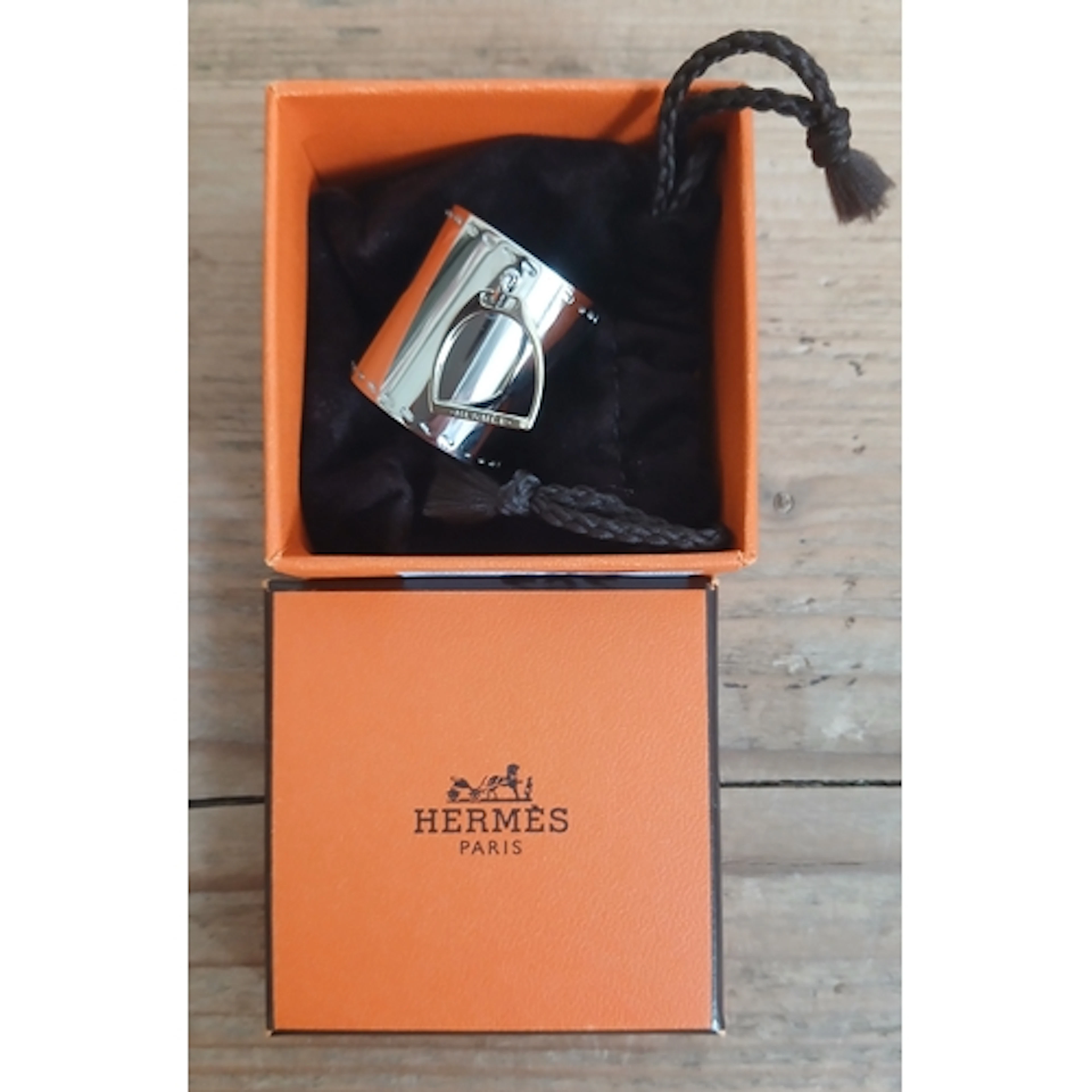 HERMES, a stirrup scarf ring with soft bag and box.