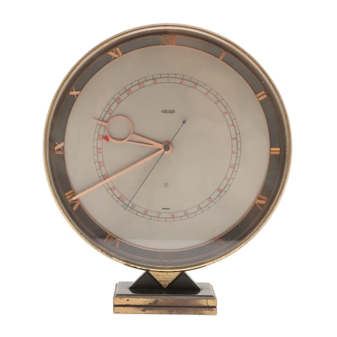 AN ART DECO JAEGER-LE-COULTRE BRASS DESK CLOCK. with 8 day p...