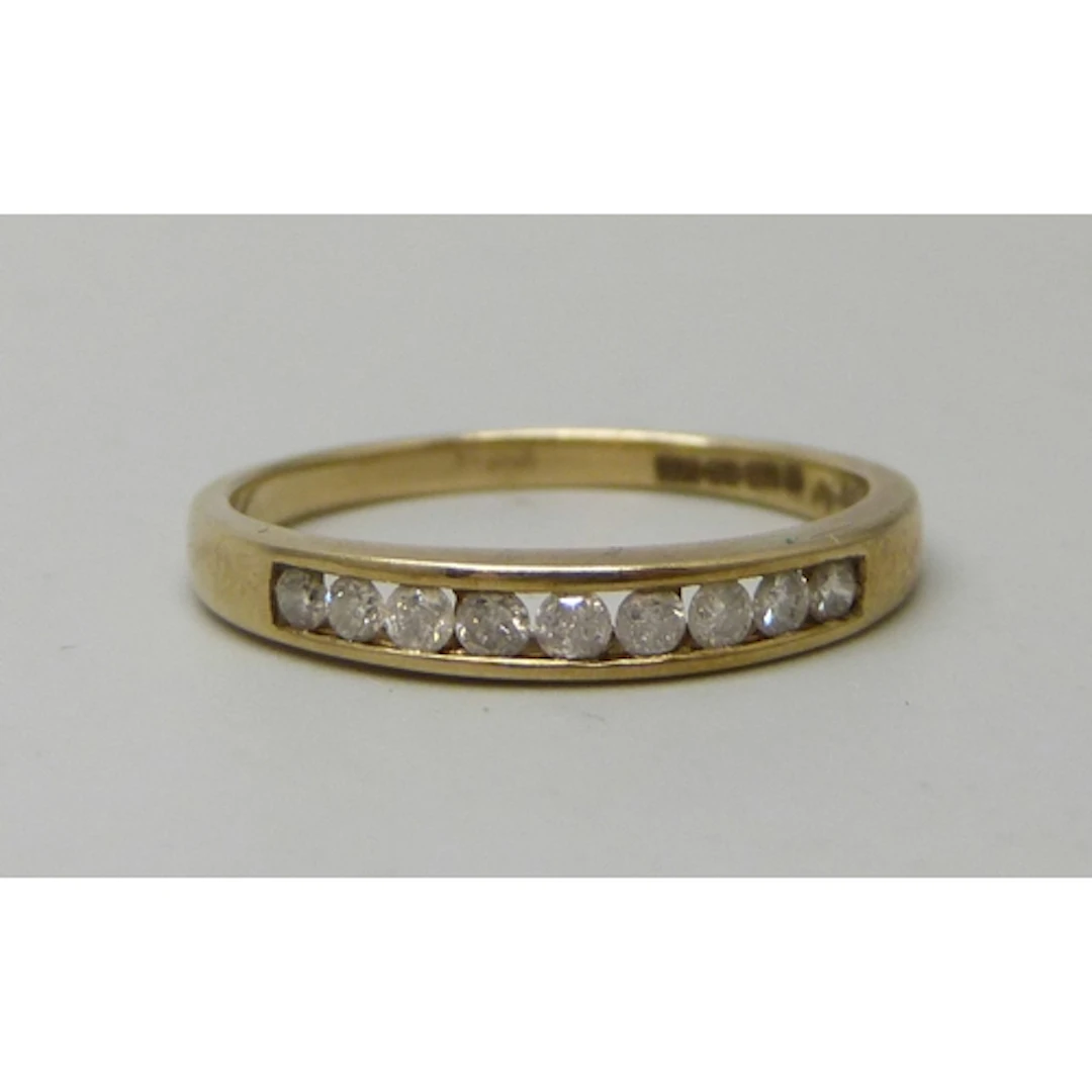 A 9ct gold and diamond half eternity ring, 2g, P
