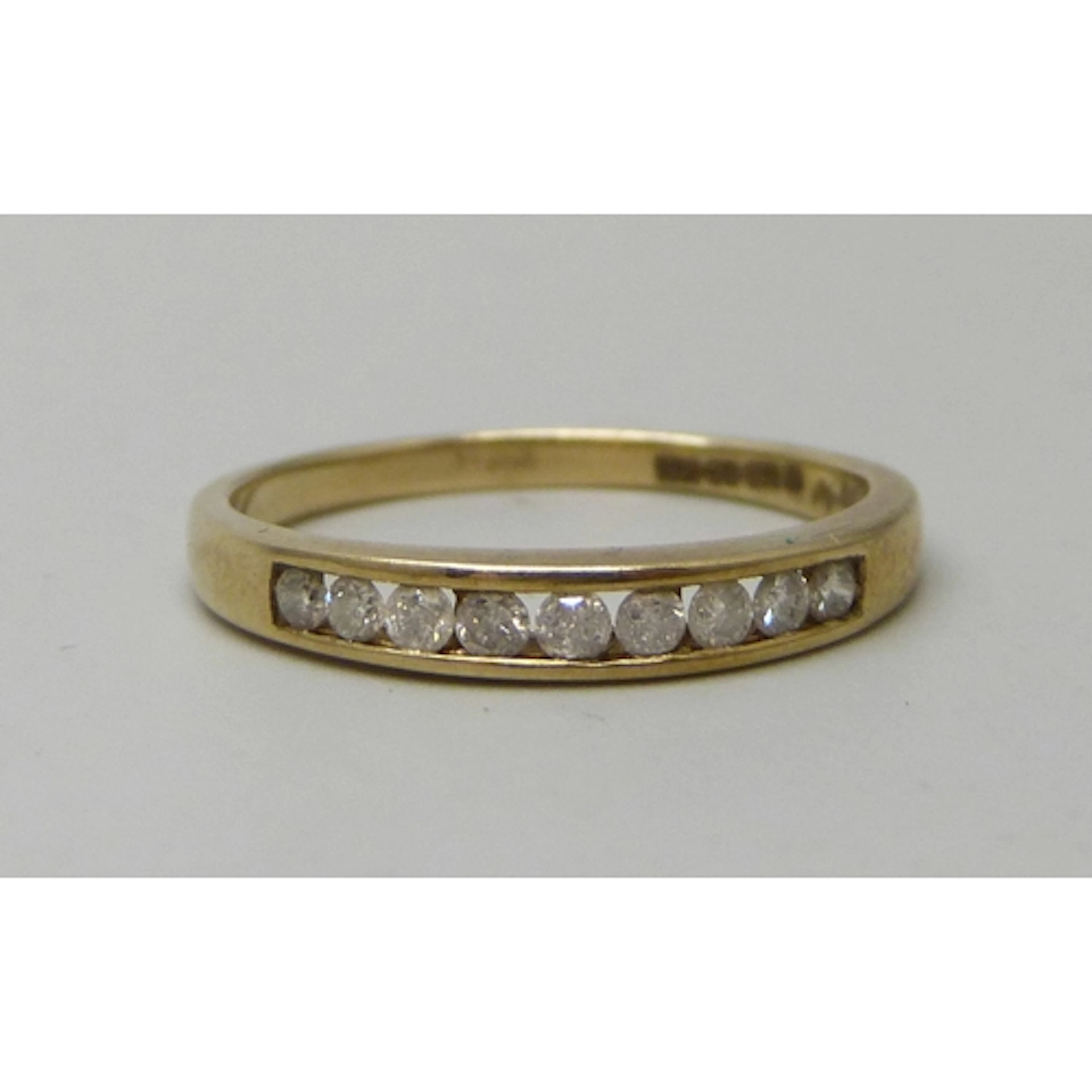 A 9ct gold and diamond half eternity ring, 2g, P