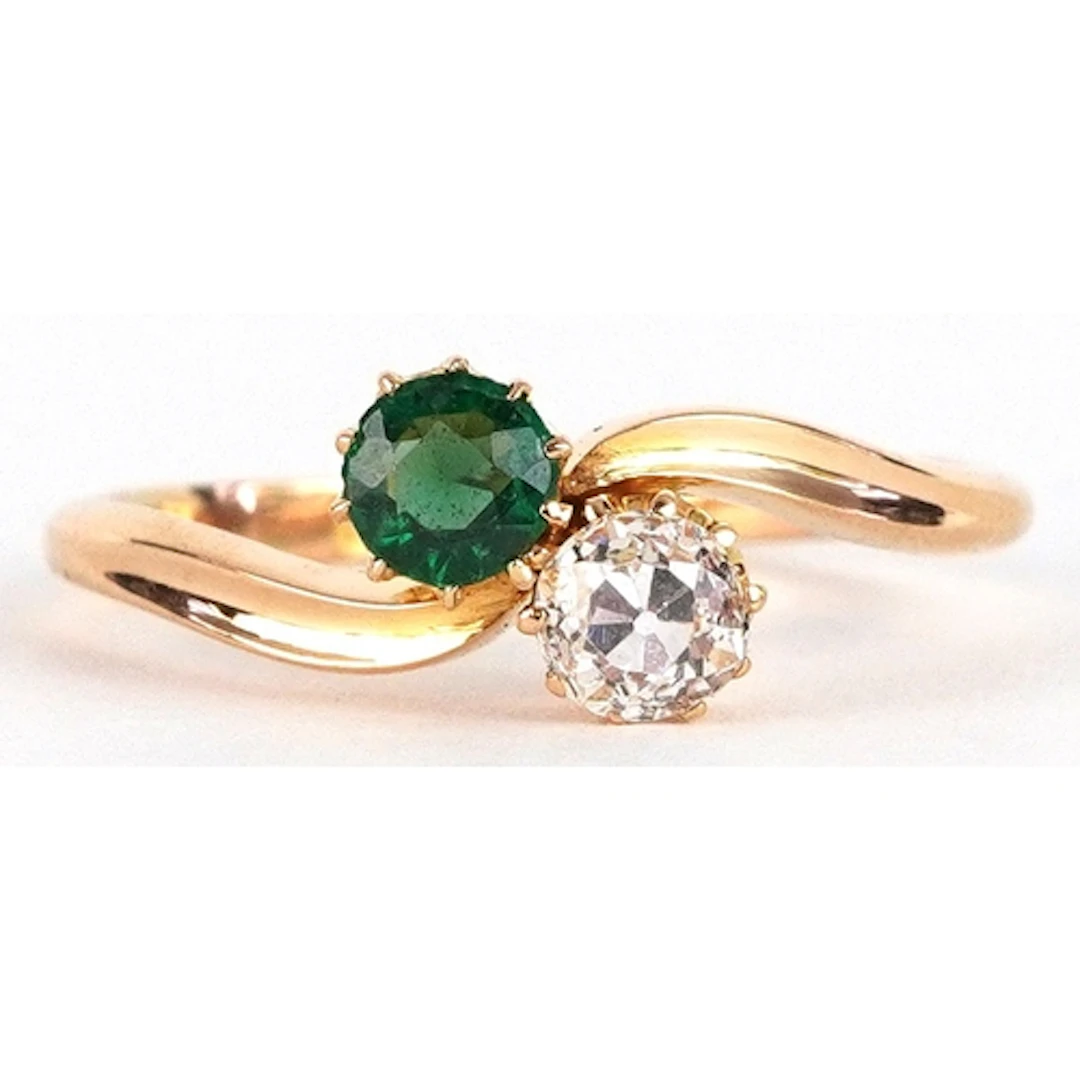 Edwardian 18ct gold diamond and emerald crossover ring, the ...