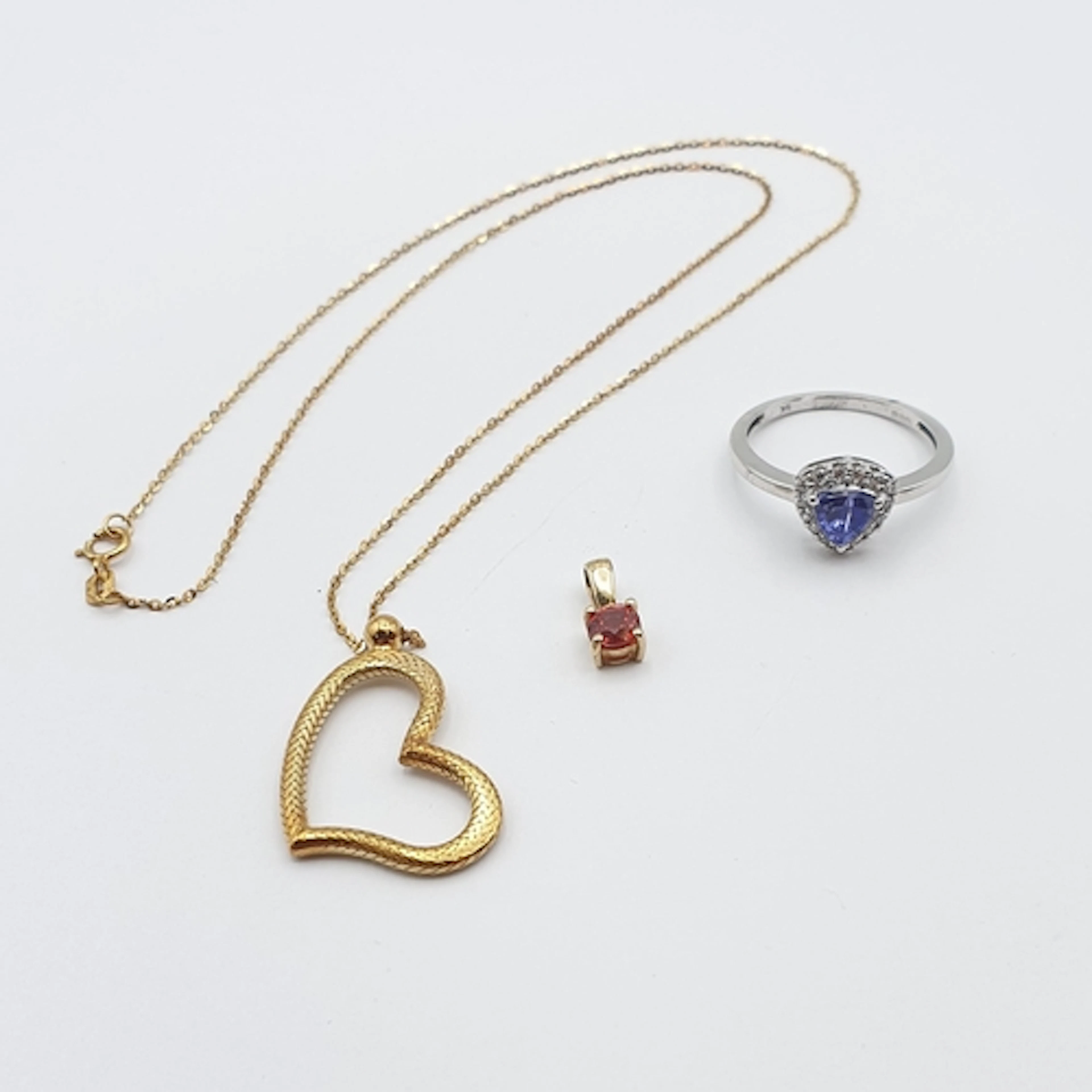 A 9ct gold Pendant set orange stone, a 9ct gold Ring set tan...