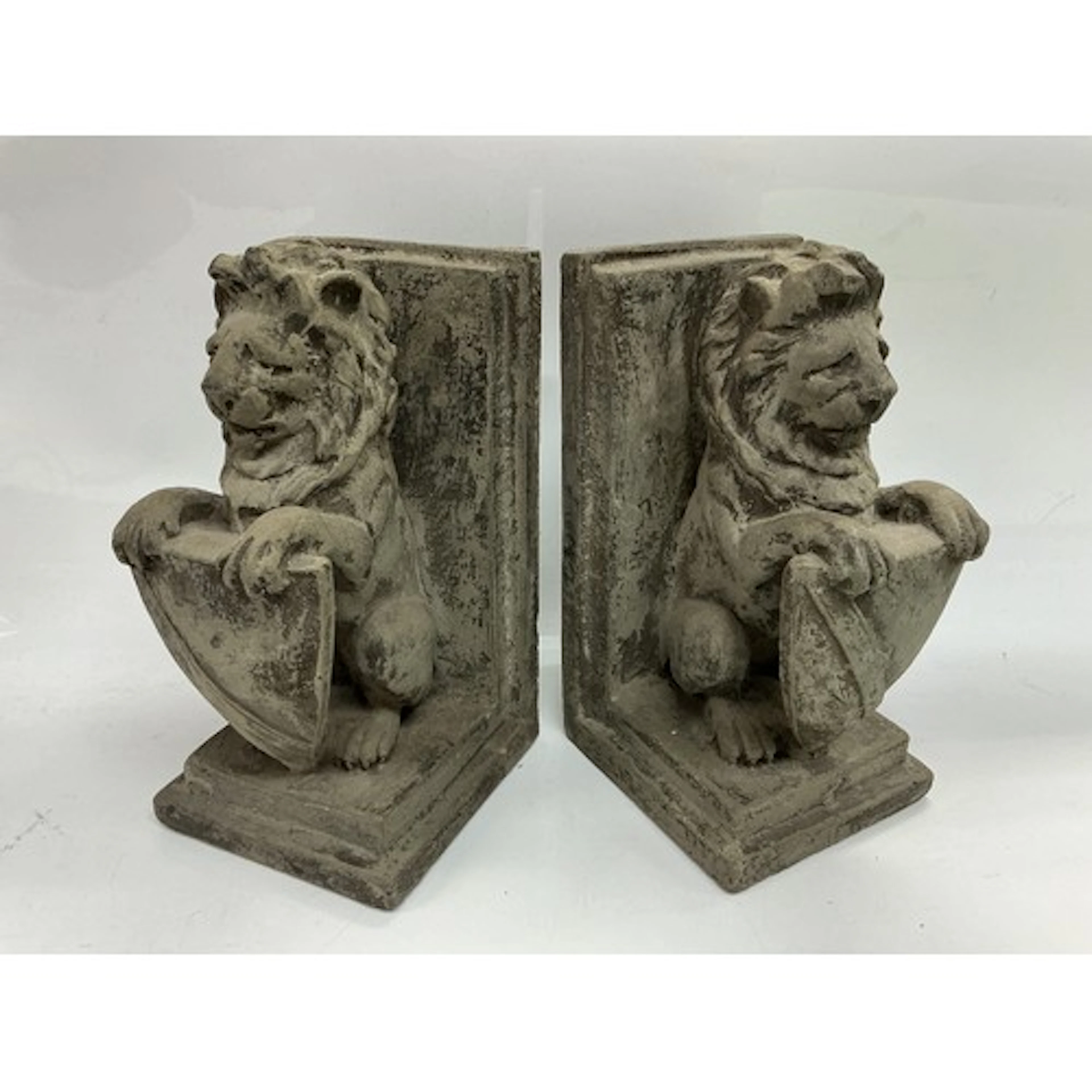 A pair of bookends in the form of lions with shields, approx...