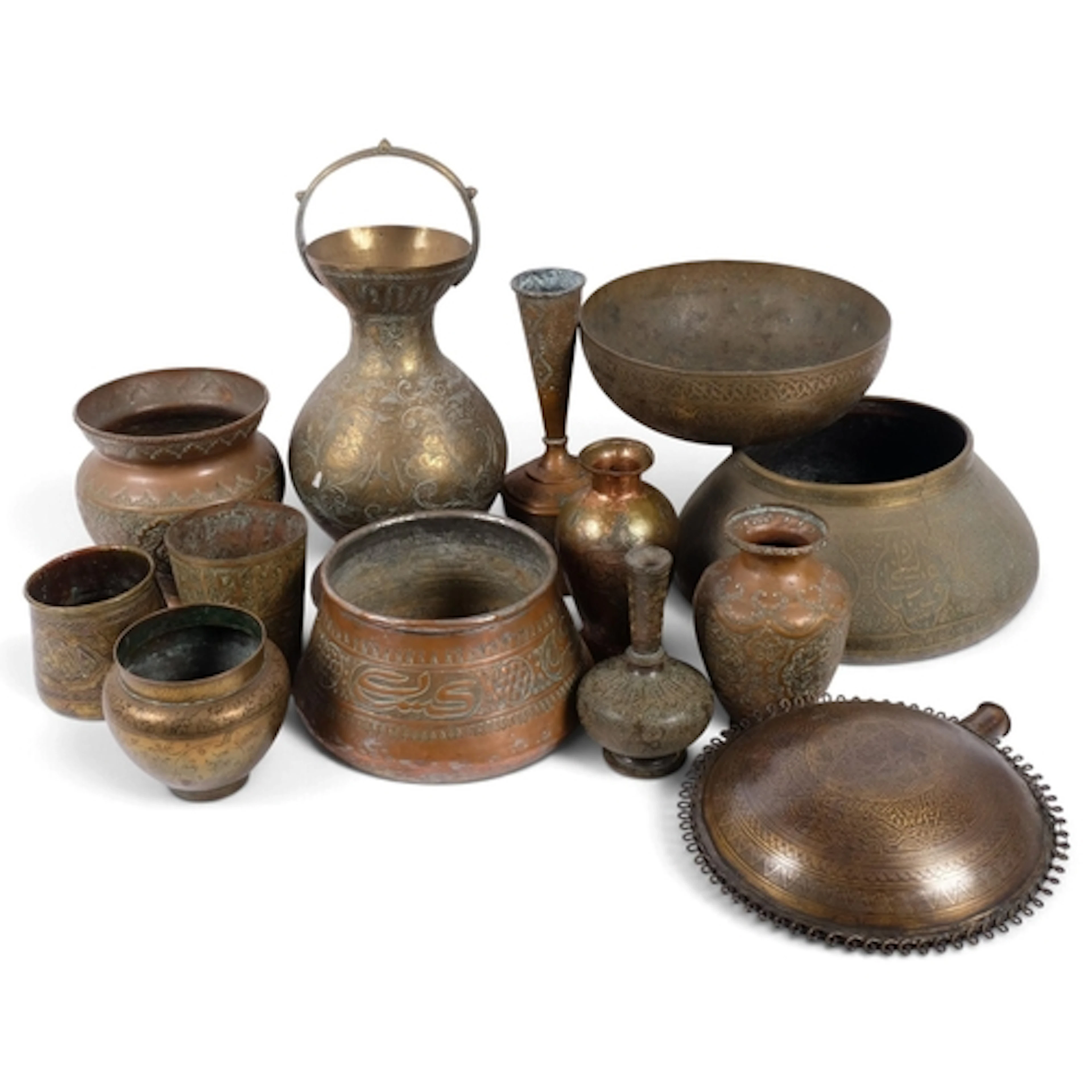A group of Islamic metalware, including a brass bowl with fi...