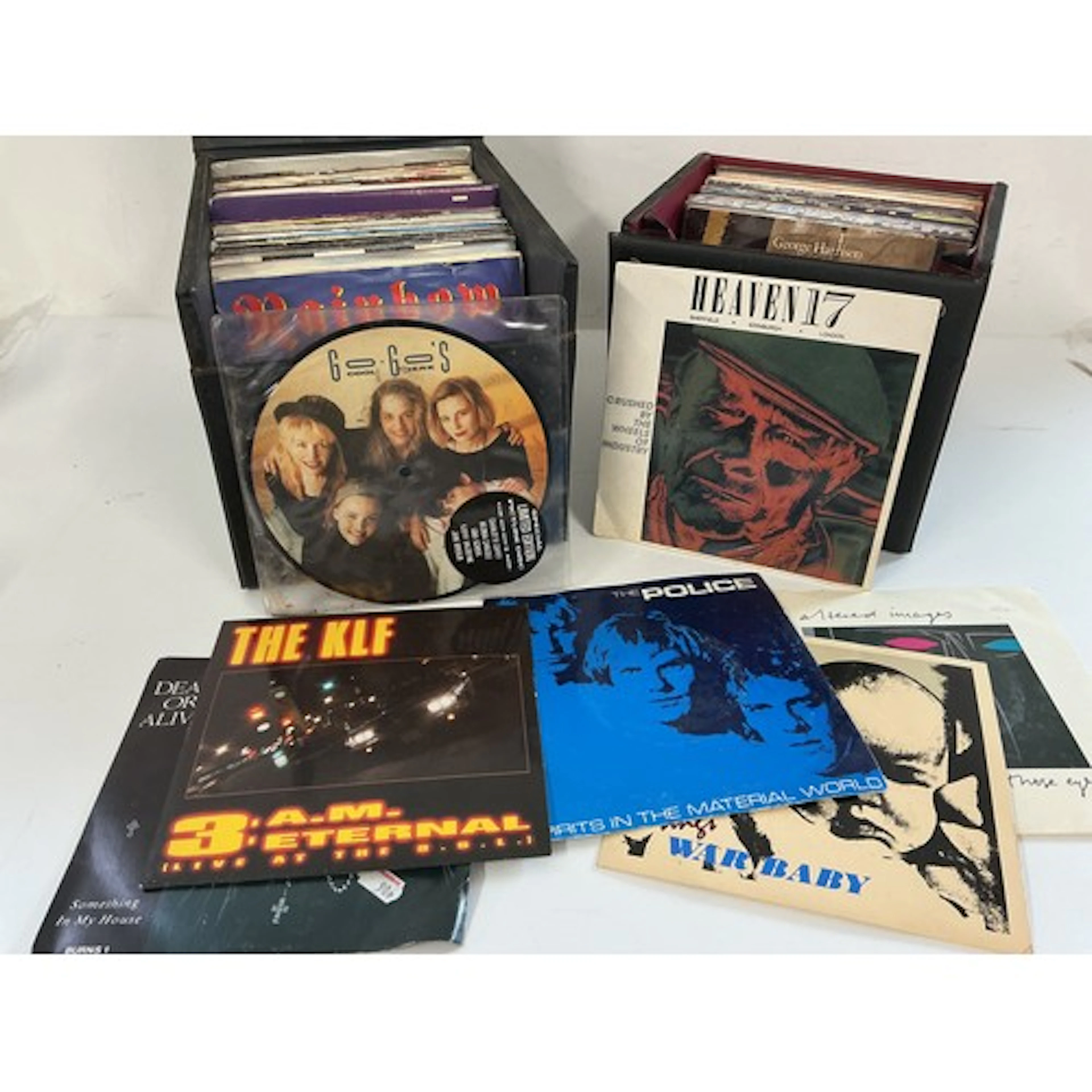Two record cases of 7” singles by various artists including ...