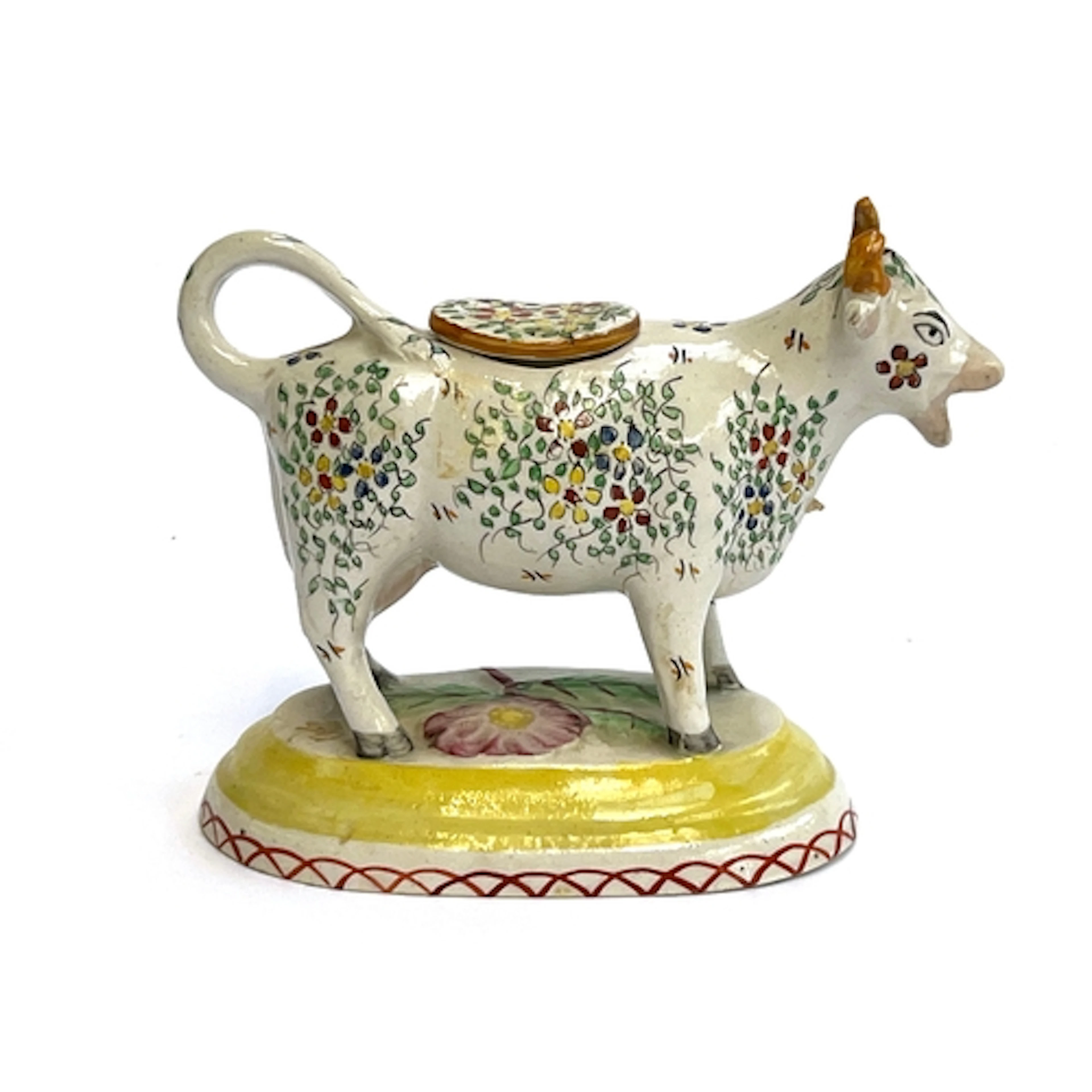 A 19th century Staffordshire cow creamer with painted flora...