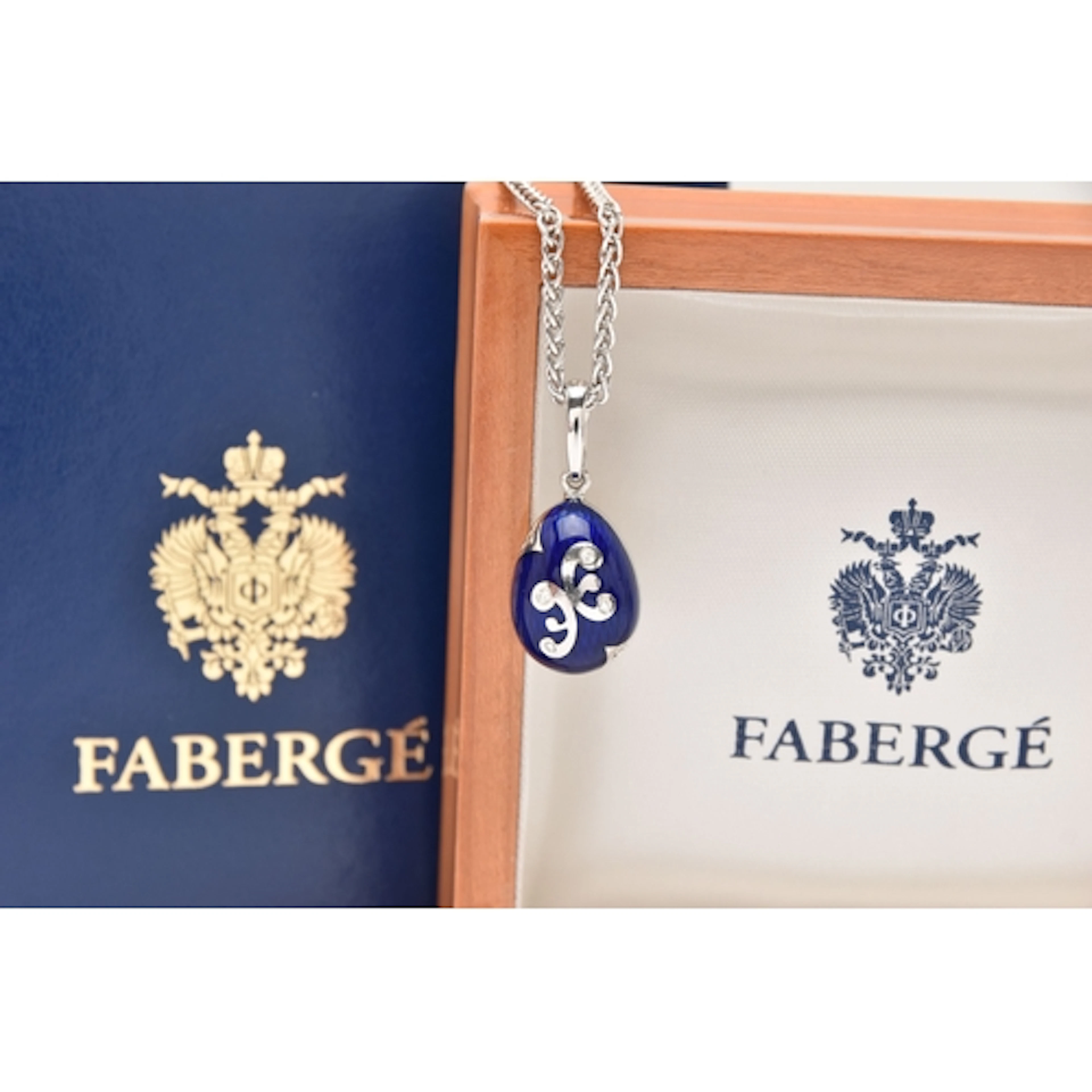 A BOXED 18CT WHITE GOLD, ENAMEL AND DIAMOND 'FABERGE' EGG PE...