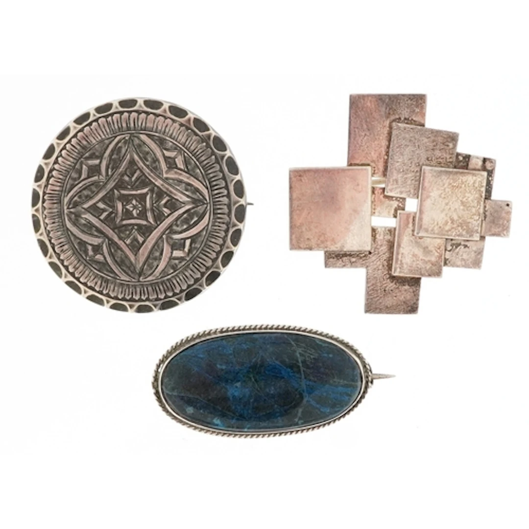 Three antique and later silver brooches including a lapis la...