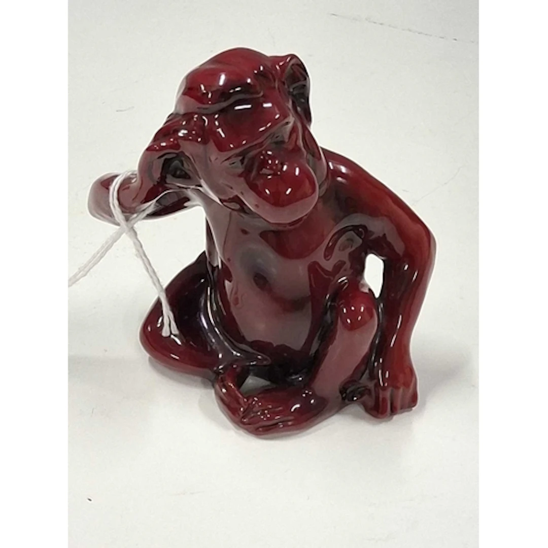 A ROYAL DOULTON FLAMBE FIGURE OF A MONKEY, the seated monkey...