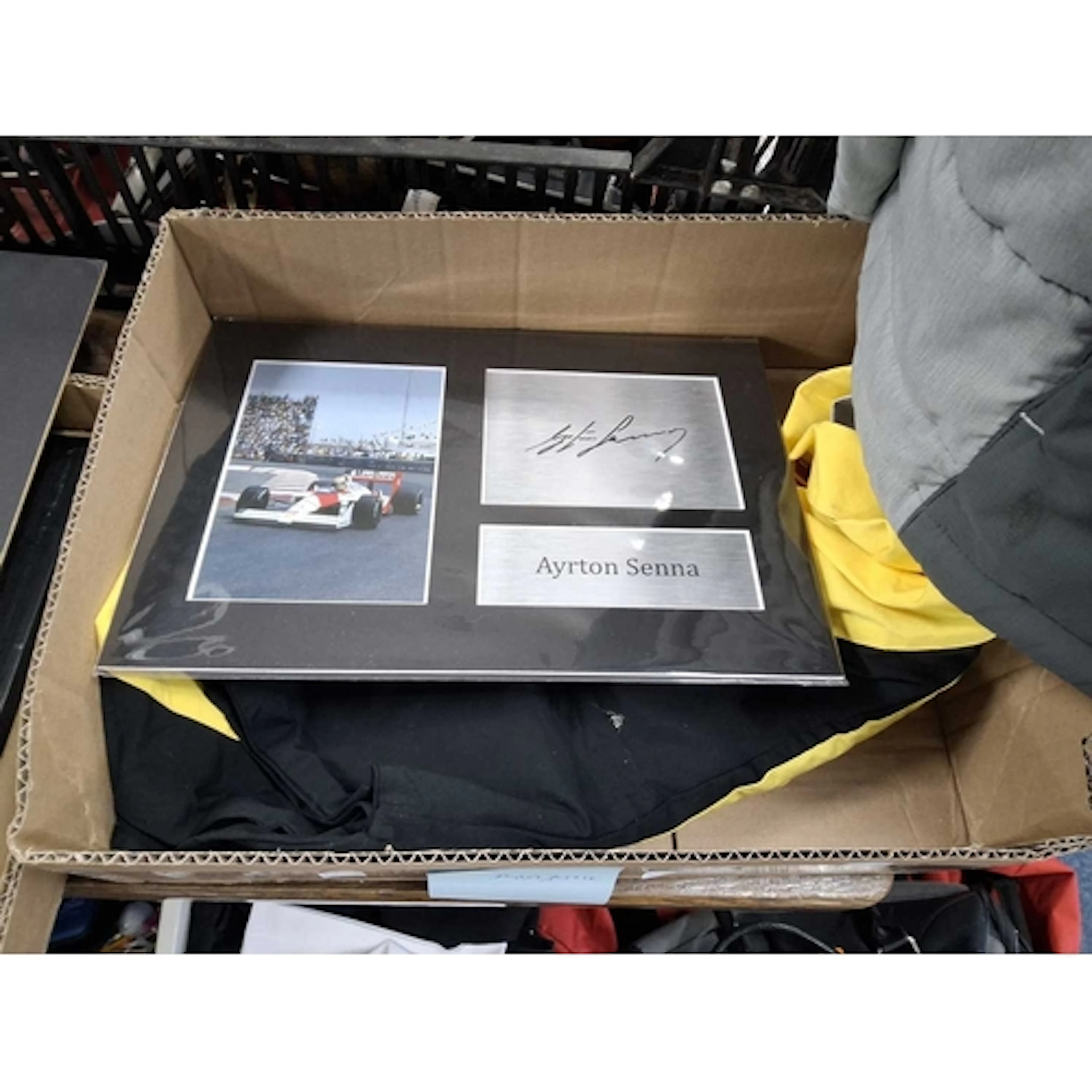 AN AYRTON SENNA SIGNATURE with a photograph of him driving a...