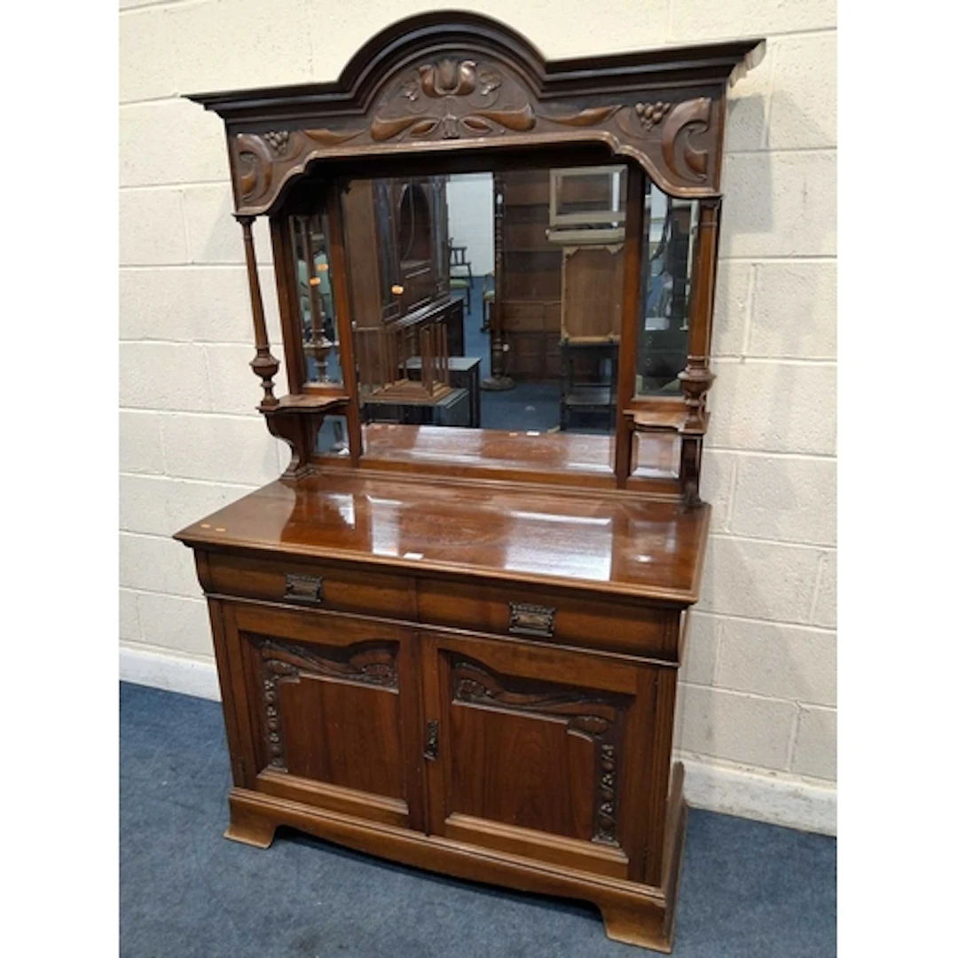 AN ART NOUVEAU WALNUT MIRROR-BACK SIDEBOARD, with an arched ...