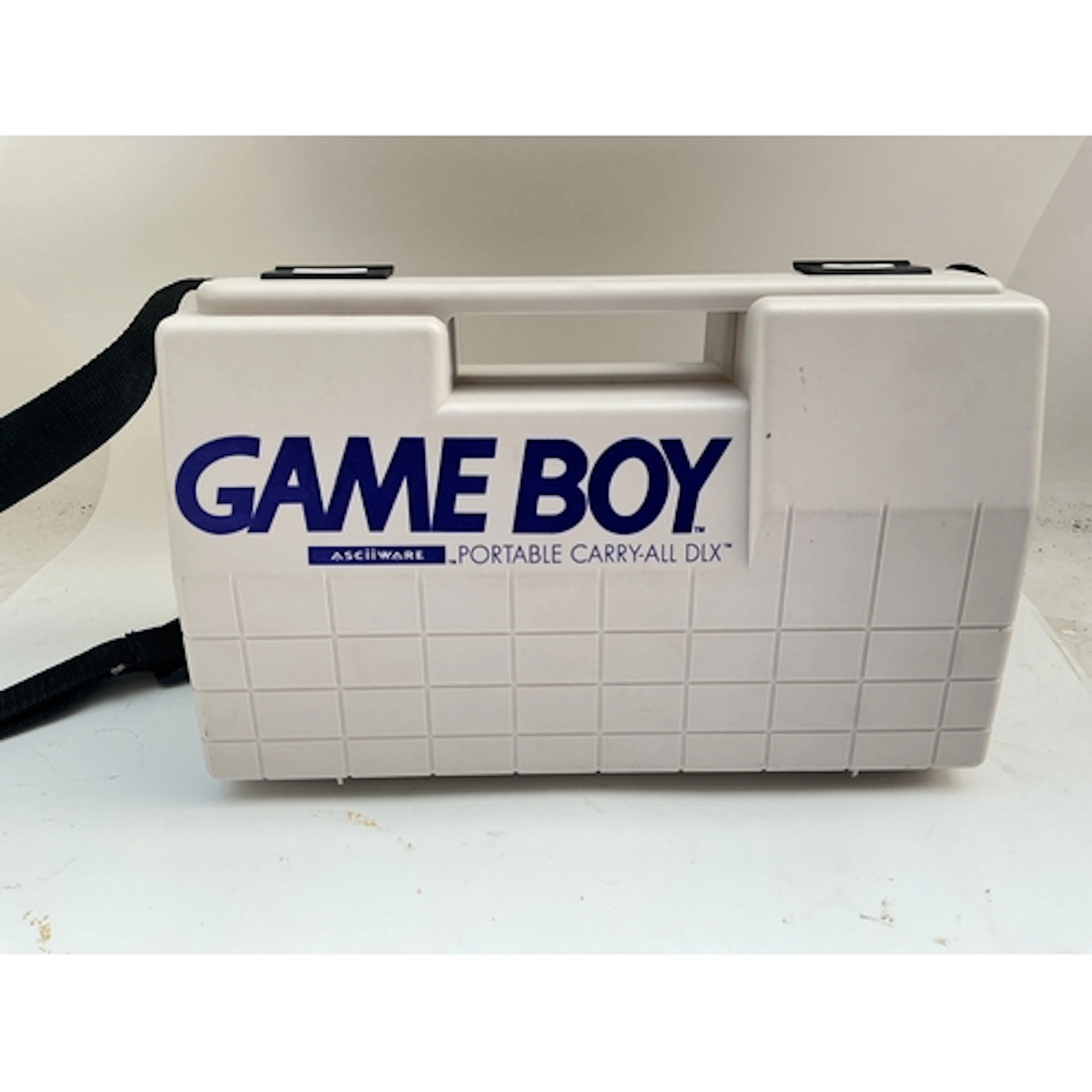 A Nintendo Gameboy In Carry Case.